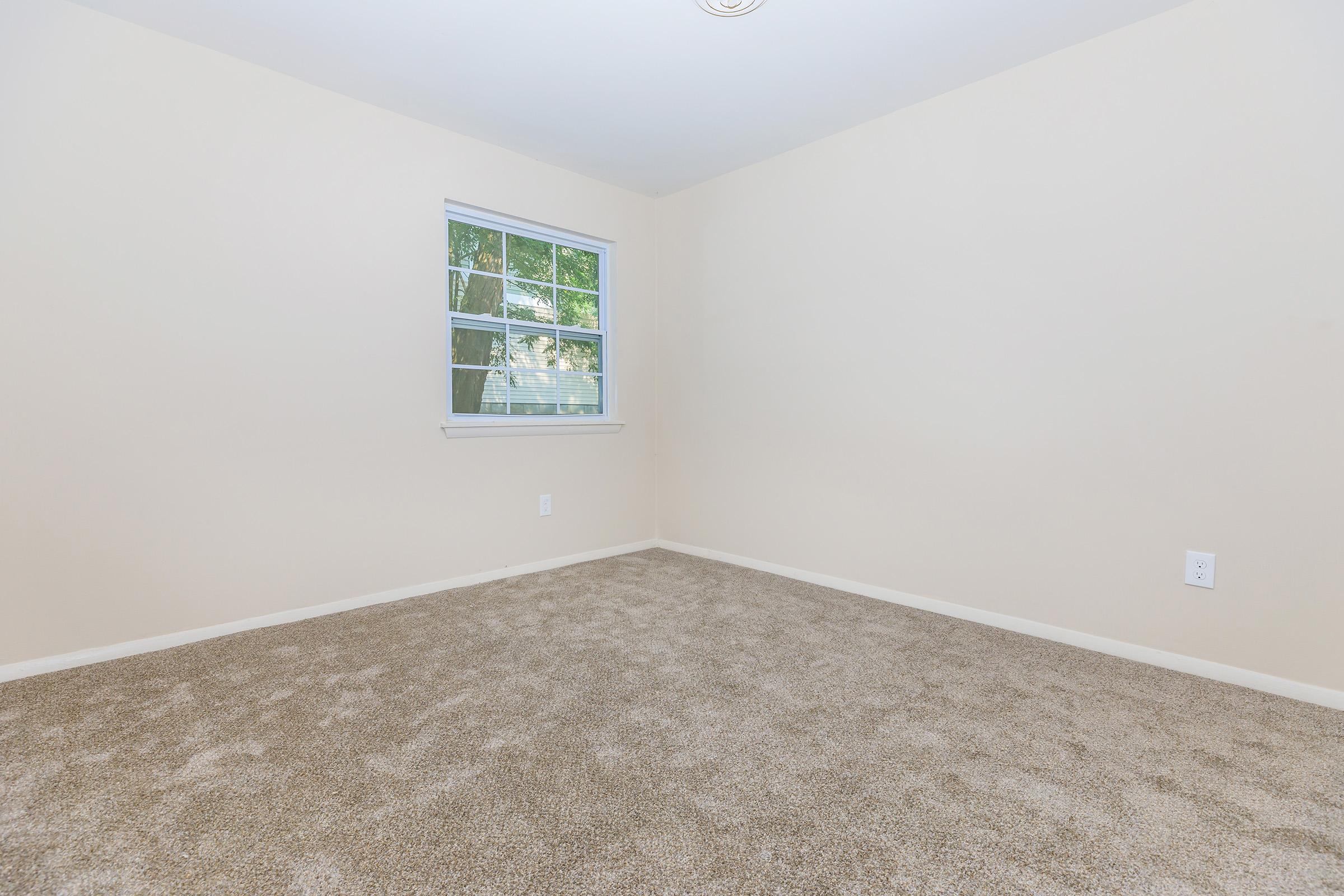 a bedroom with a large window