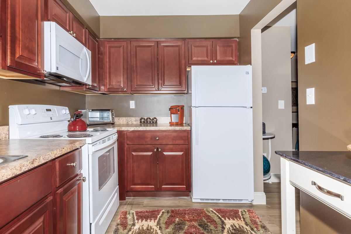 a kitchen with stainless steel appliances and wooden cabinets