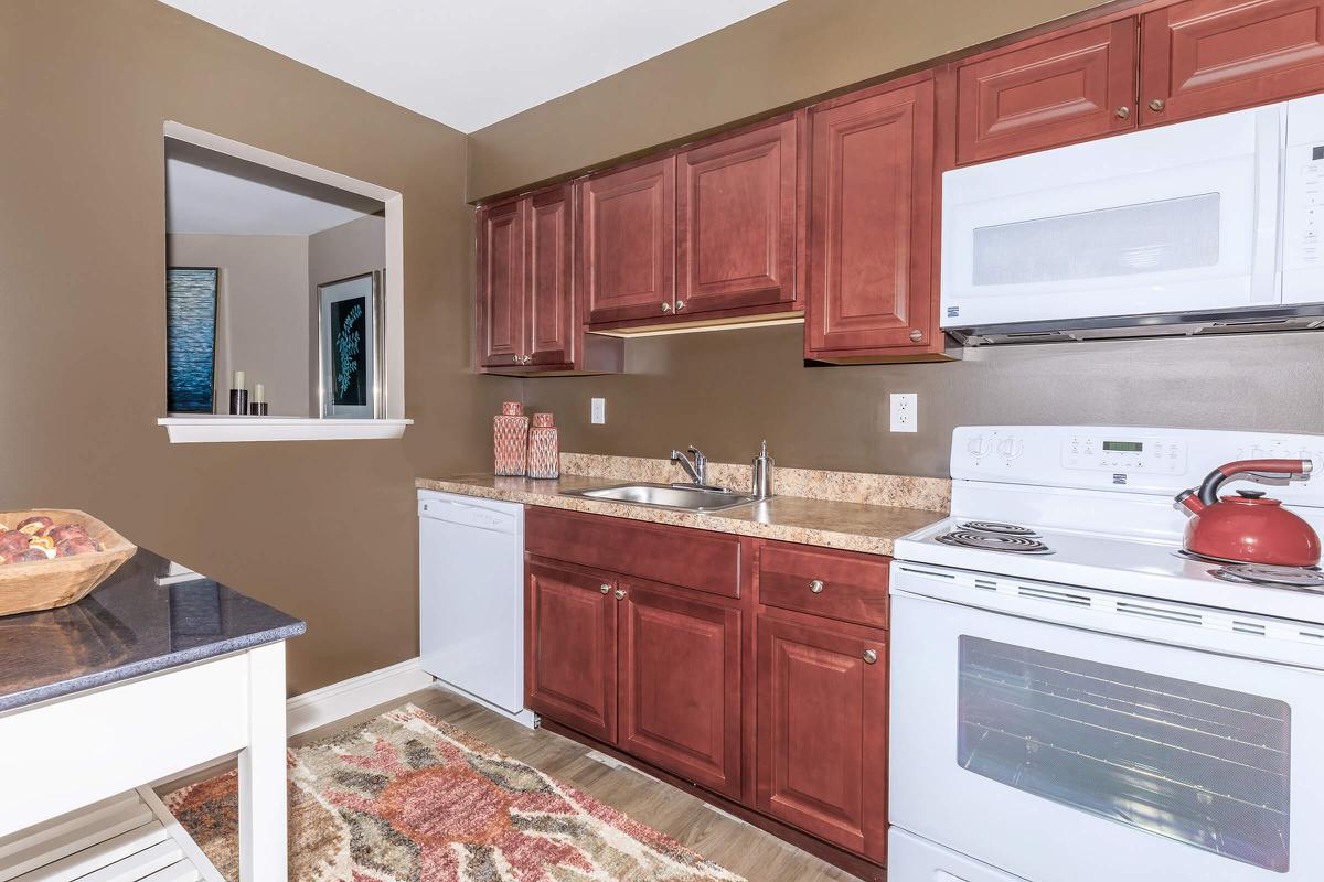 a kitchen with a stove a sink and a microwave