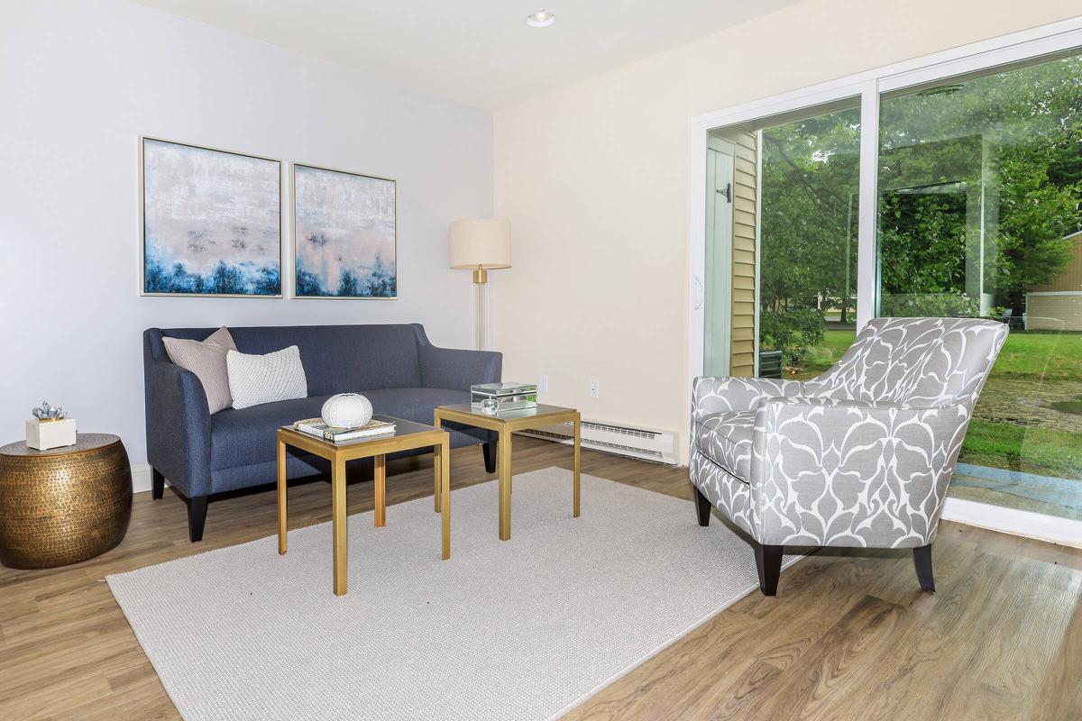 a living room filled with furniture and a large window