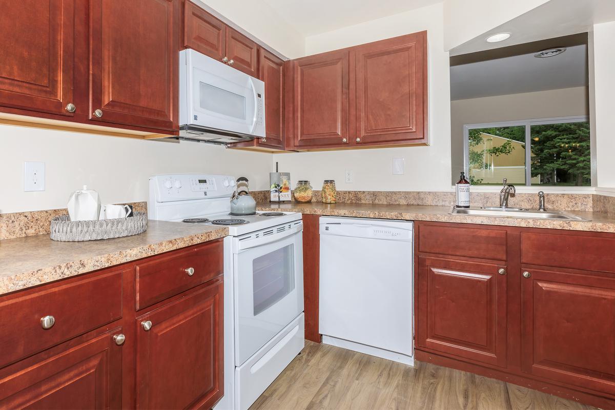 a kitchen with stainless steel appliances and wooden cabinets