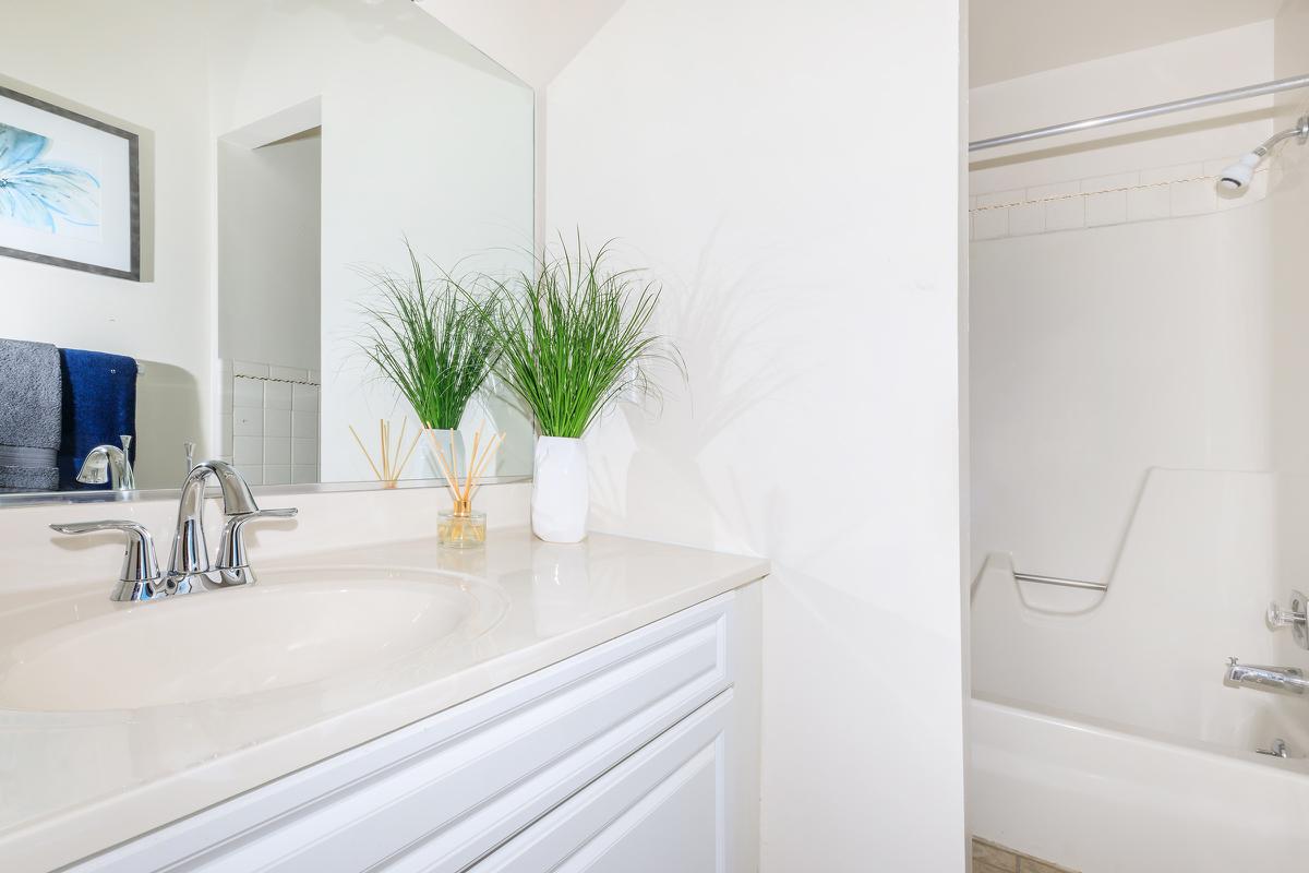 a large white tub sitting next to a window