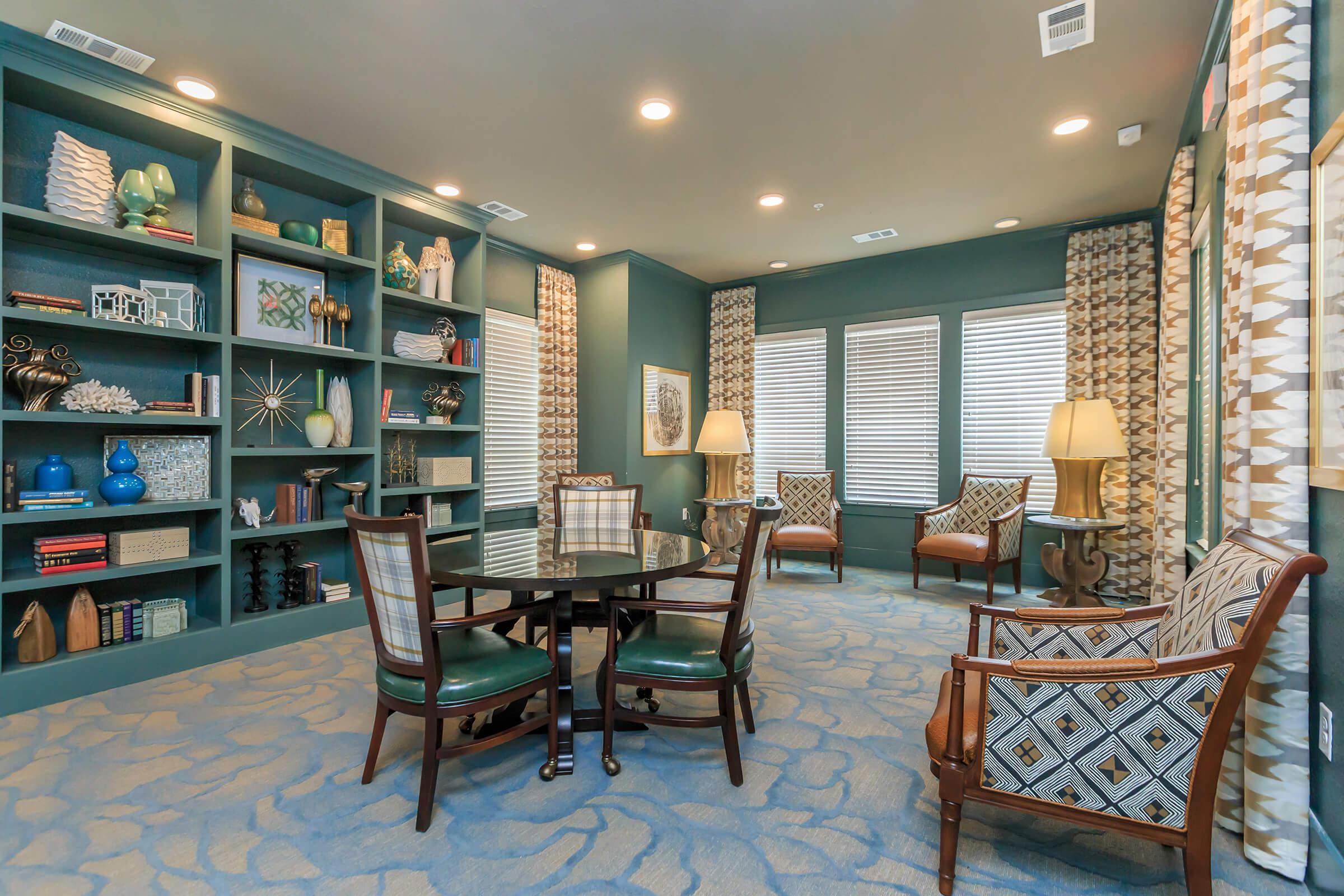 a living room filled with furniture and a large window