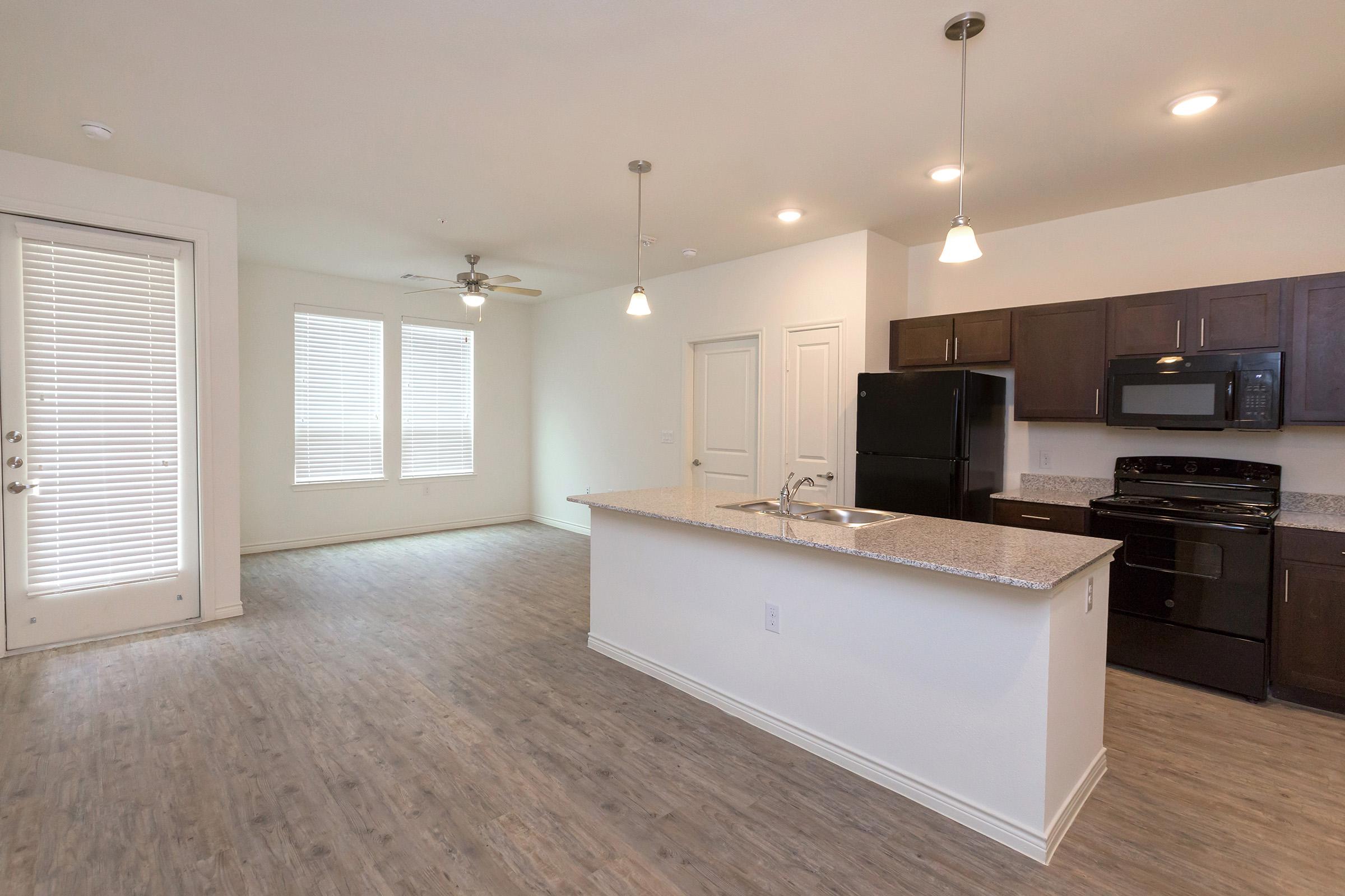 a modern kitchen with an island in the middle of a room