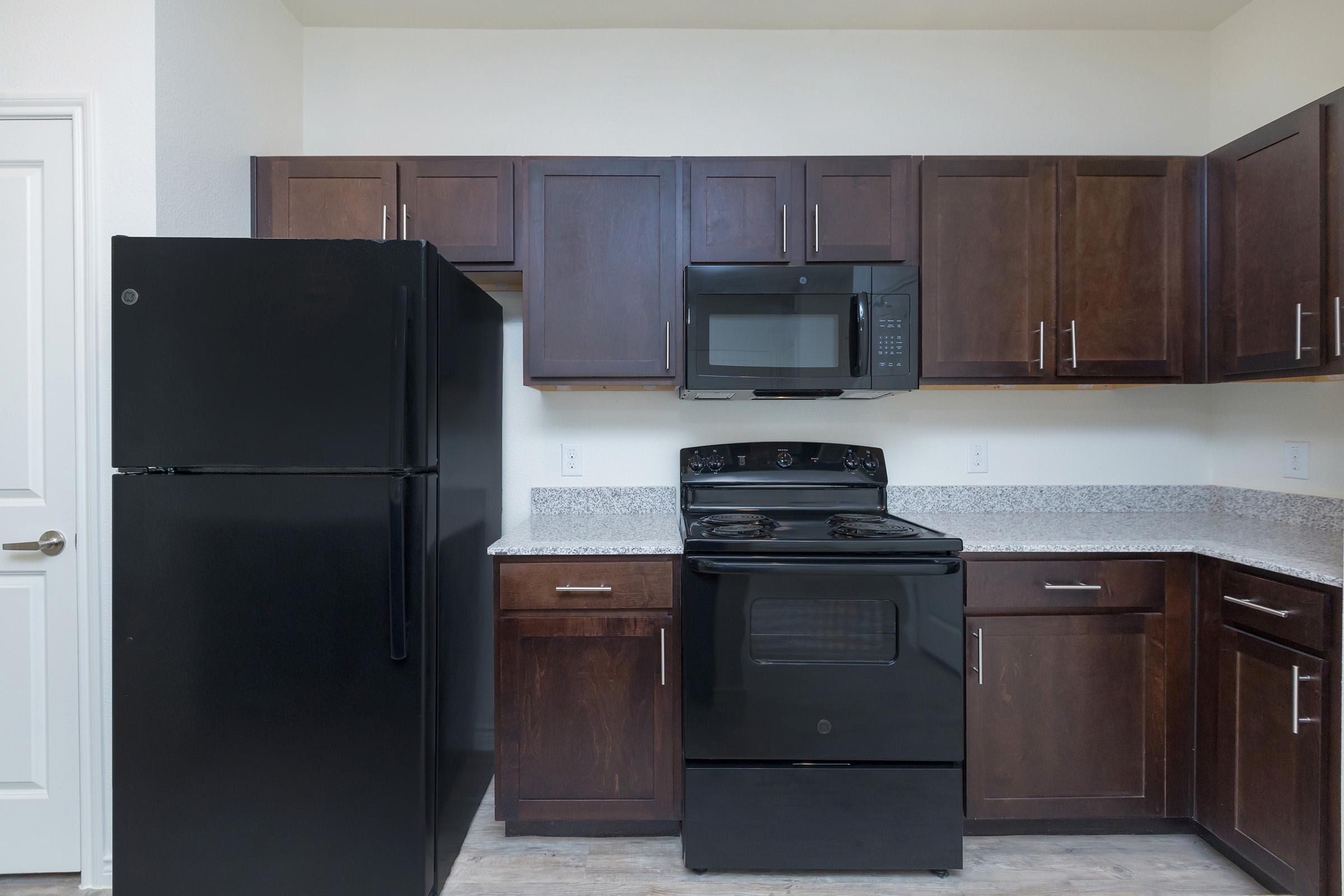 a kitchen with a stove and a refrigerator