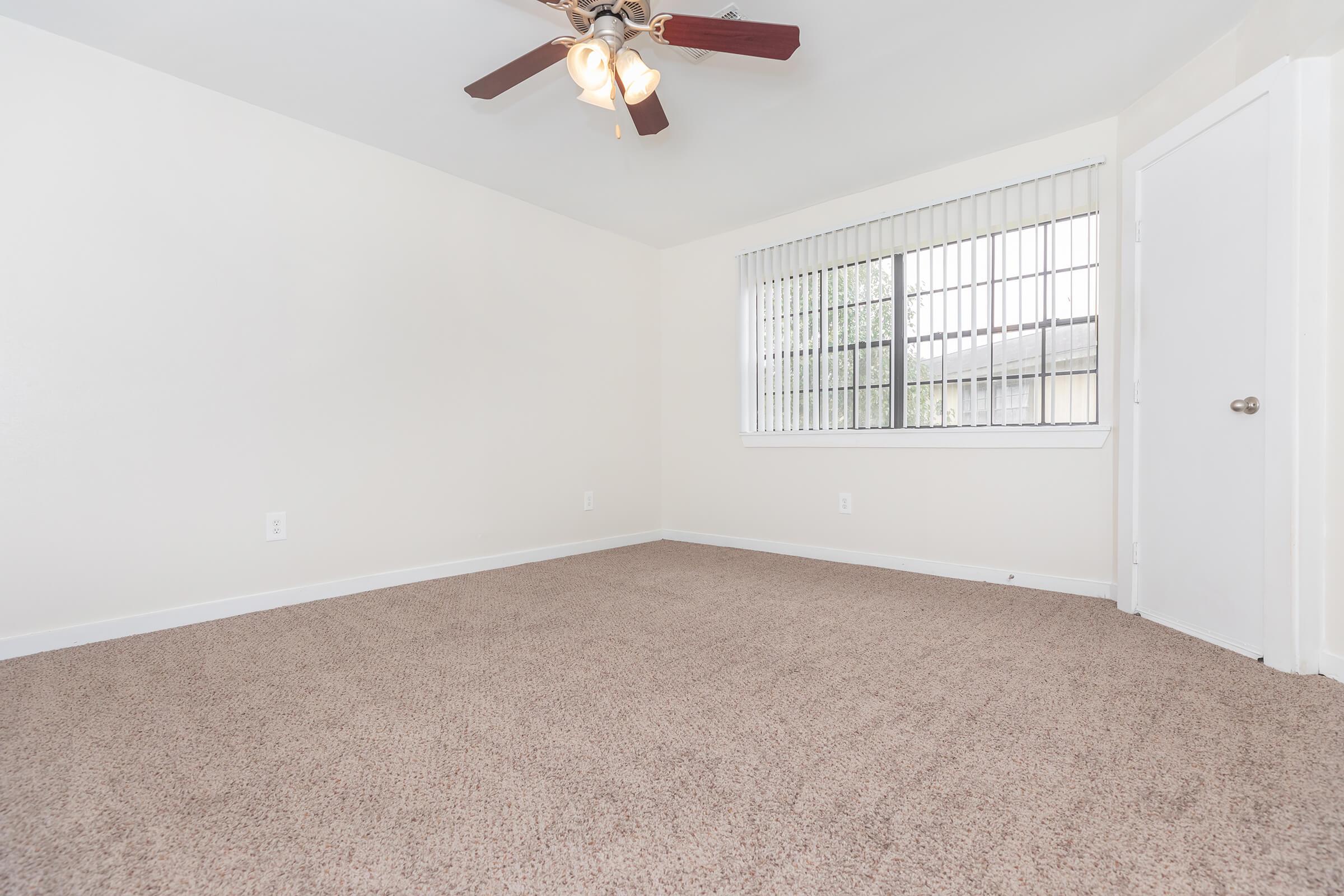 a bedroom with a large window