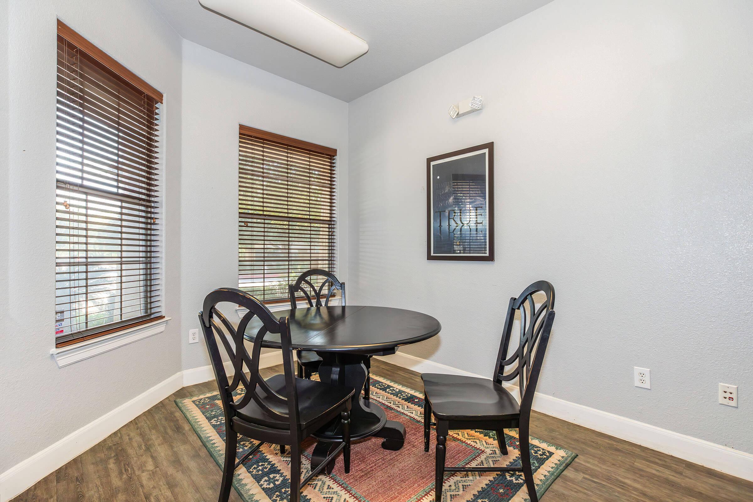 a living room filled with furniture and a large window