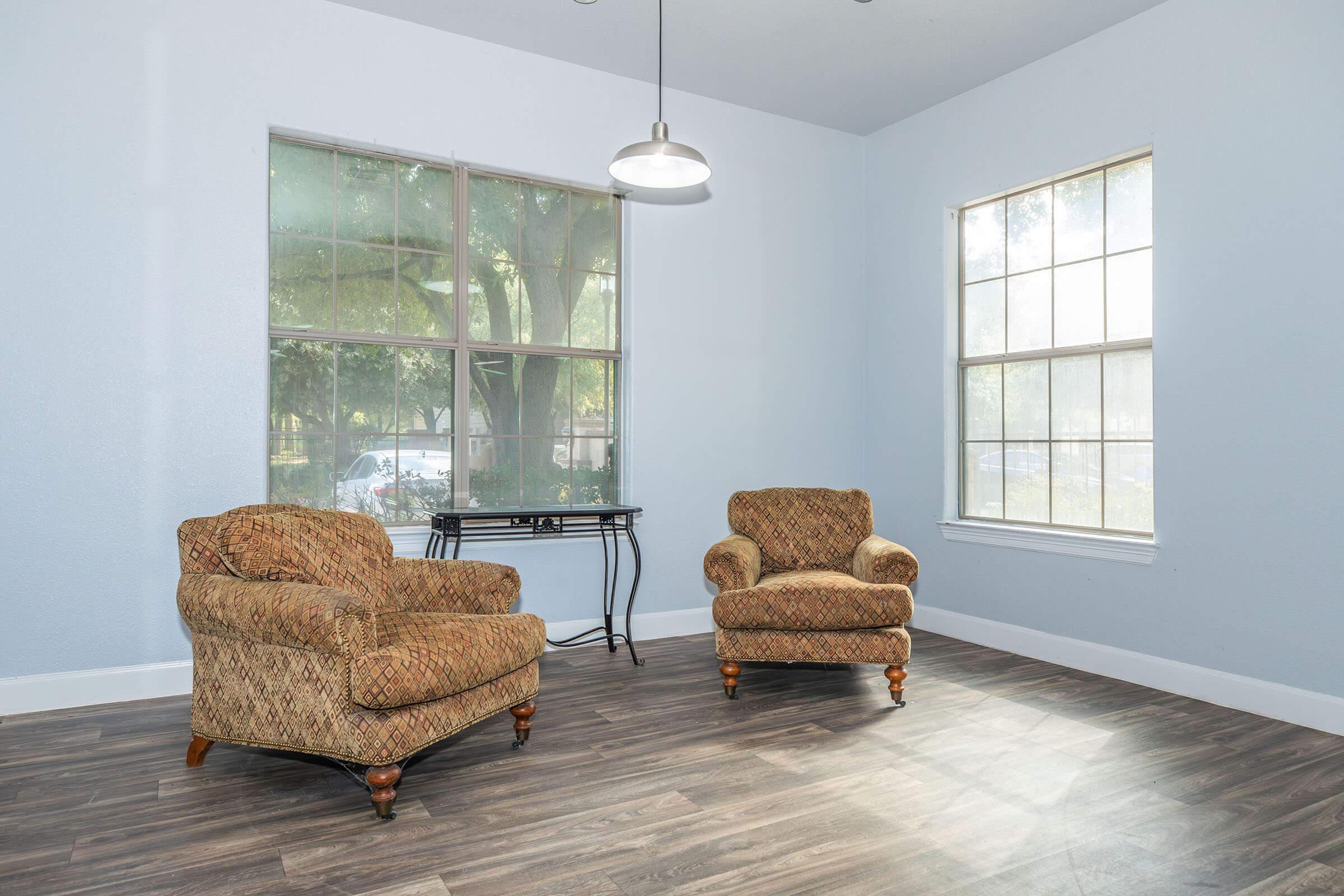 a living room filled with furniture and a large window