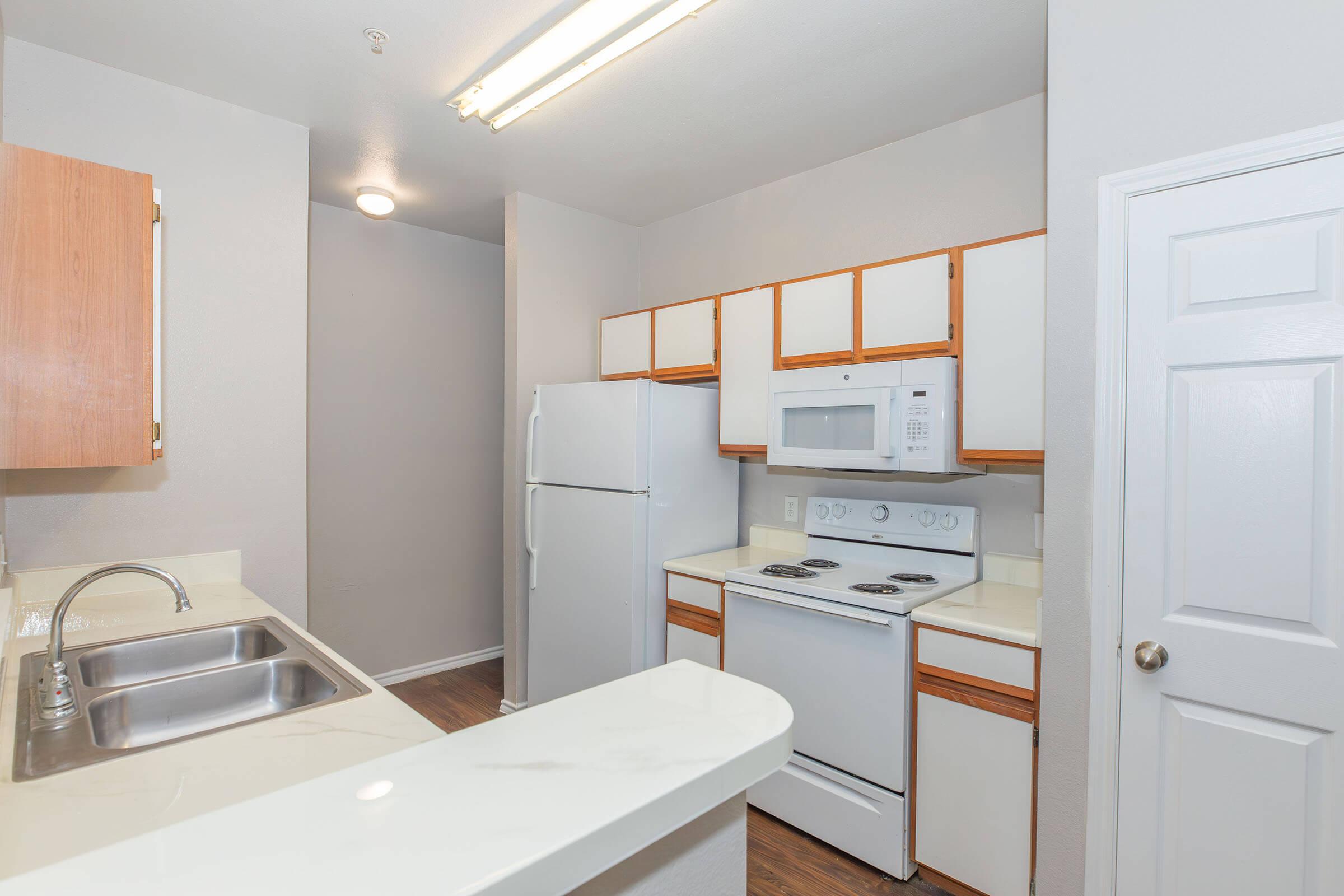 a kitchen with a sink and a mirror