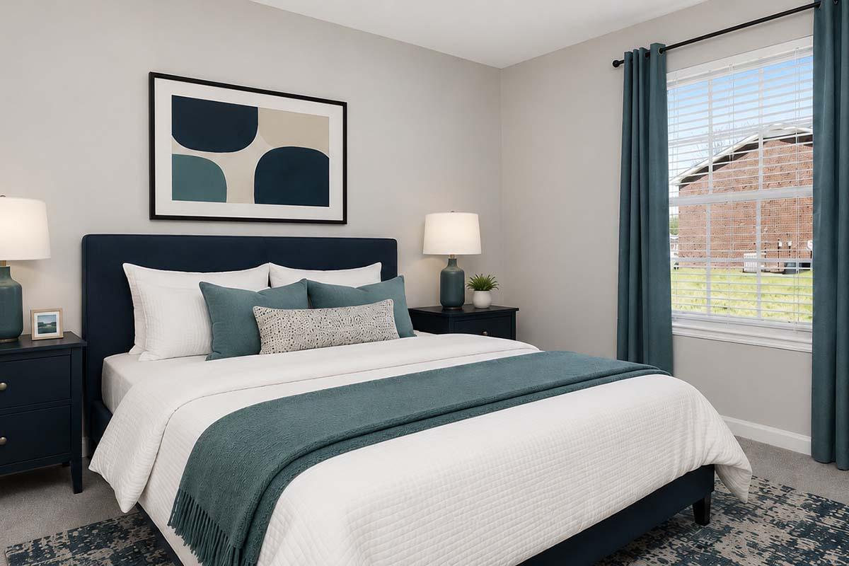 A modern bedroom featuring a queen-sized bed with white linens and teal accents, two bedside lamps, a dark blue upholstered headboard, and matching nightstands. A large piece of abstract artwork is mounted on the wall above the bed. The room has a bright window with sheer curtains, allowing natural light to flow in.
