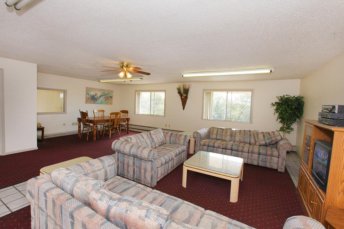 a living room filled with furniture and a flat screen tv