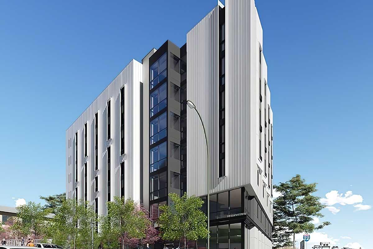 A modern, multi-story building with a sleek facade featuring a combination of glass and vertical panels.