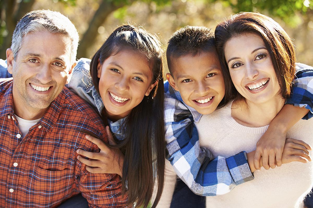 Happy Hispanic family outdoors in country .jpg