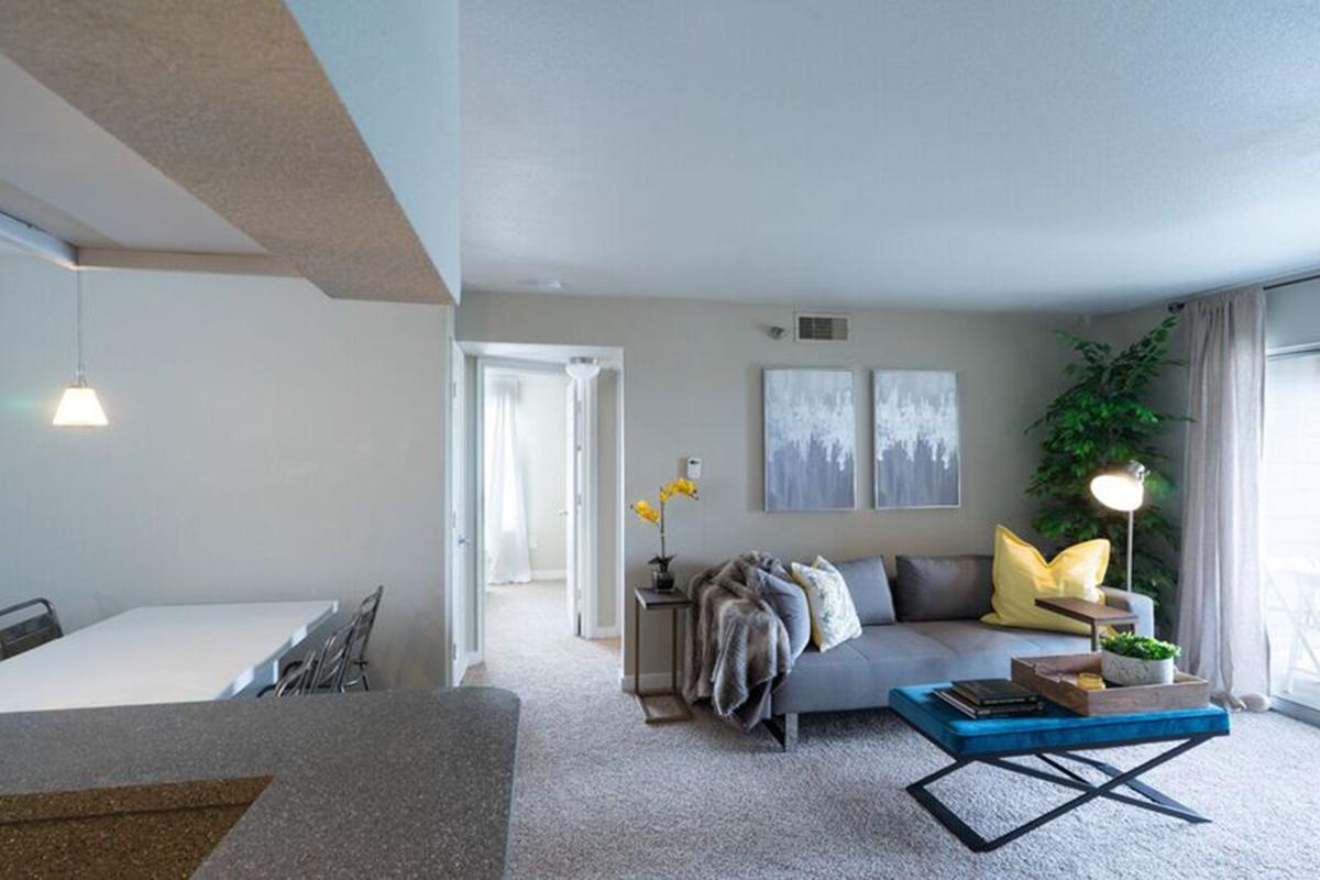 a living room filled with furniture and a large window