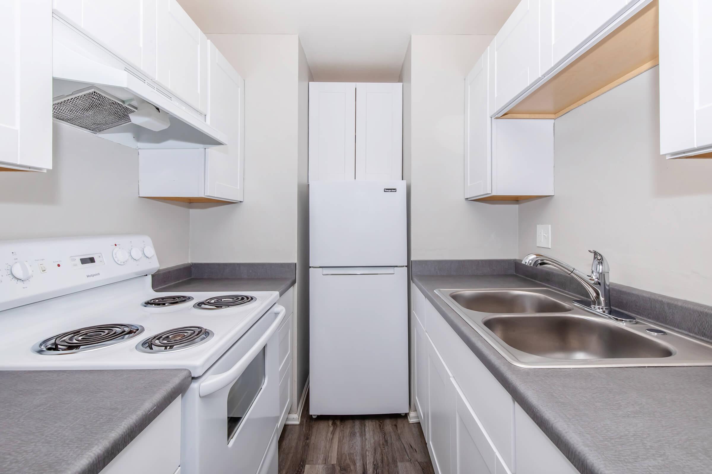 a stove top oven sitting inside of a kitchen