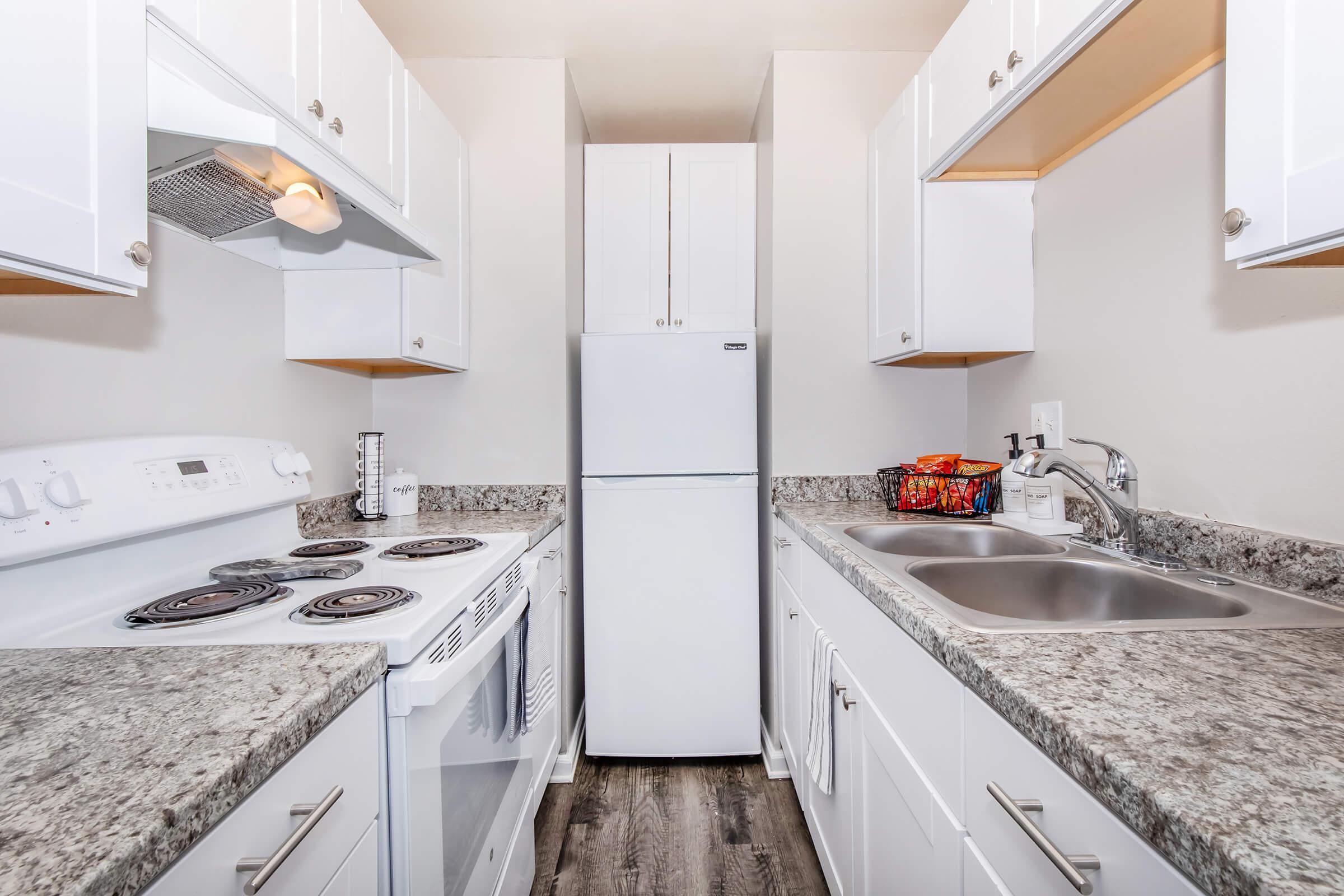 a kitchen with a sink and a mirror