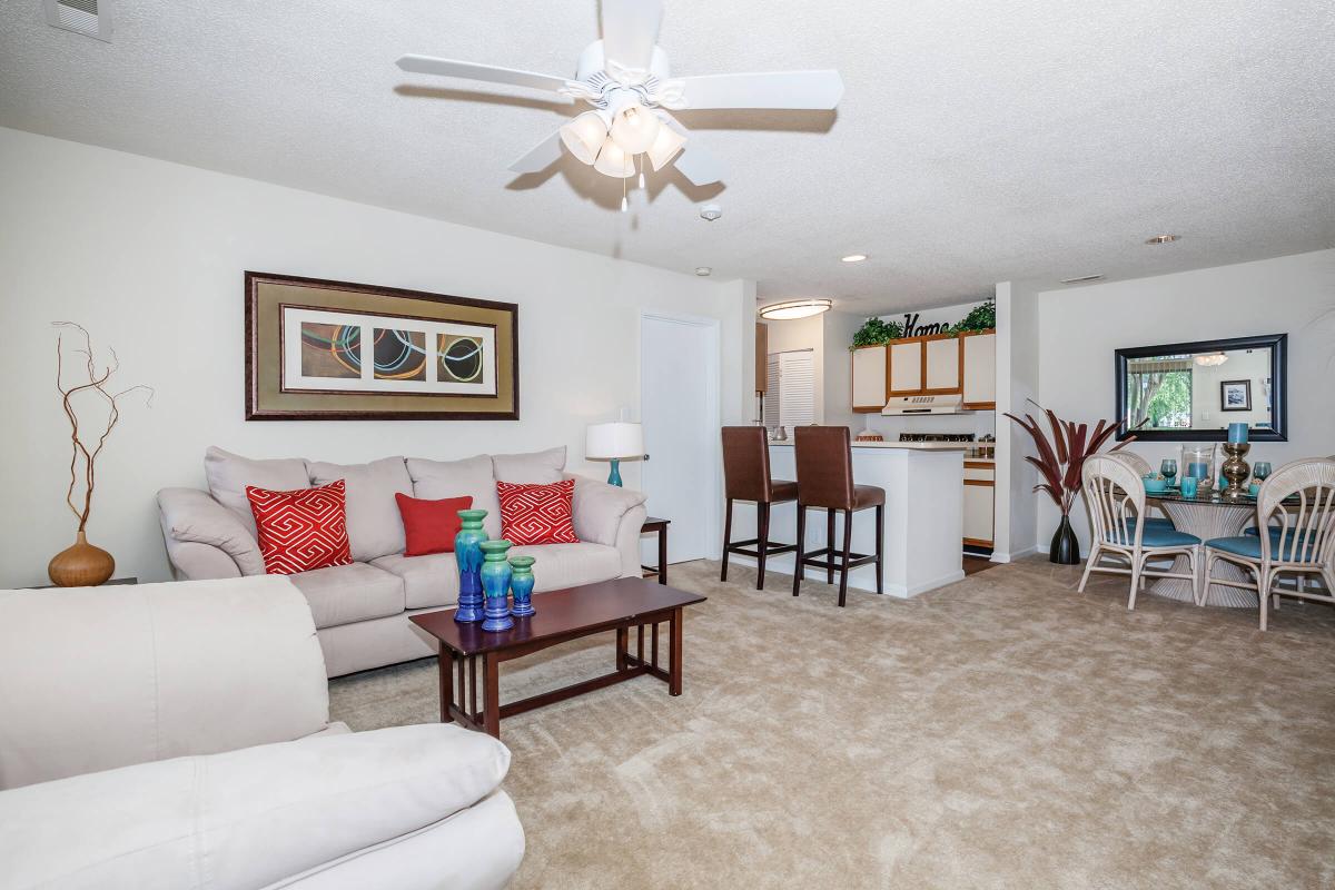 a living room filled with furniture and a flat screen tv