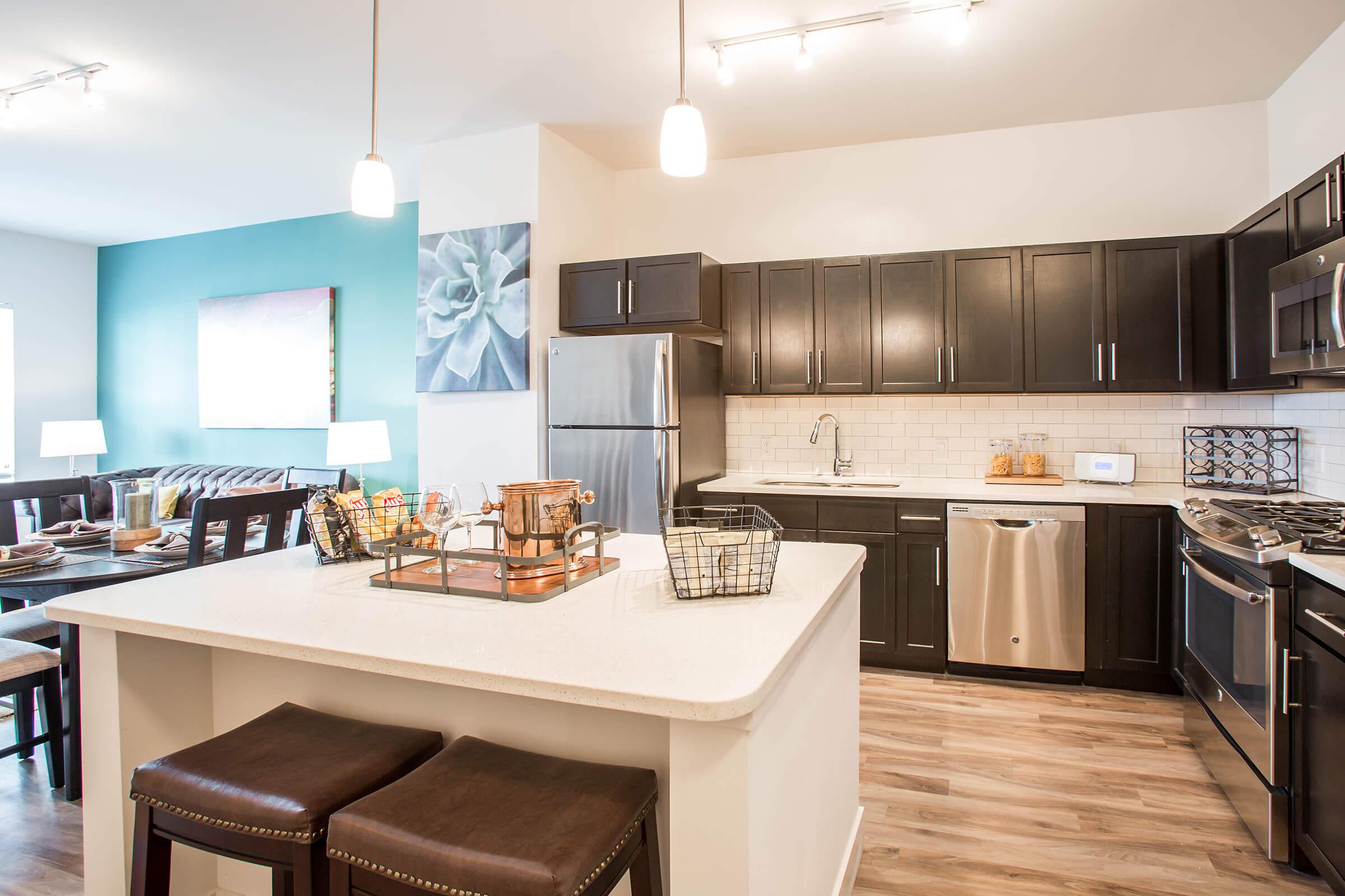 a kitchen with an island in the middle of a room