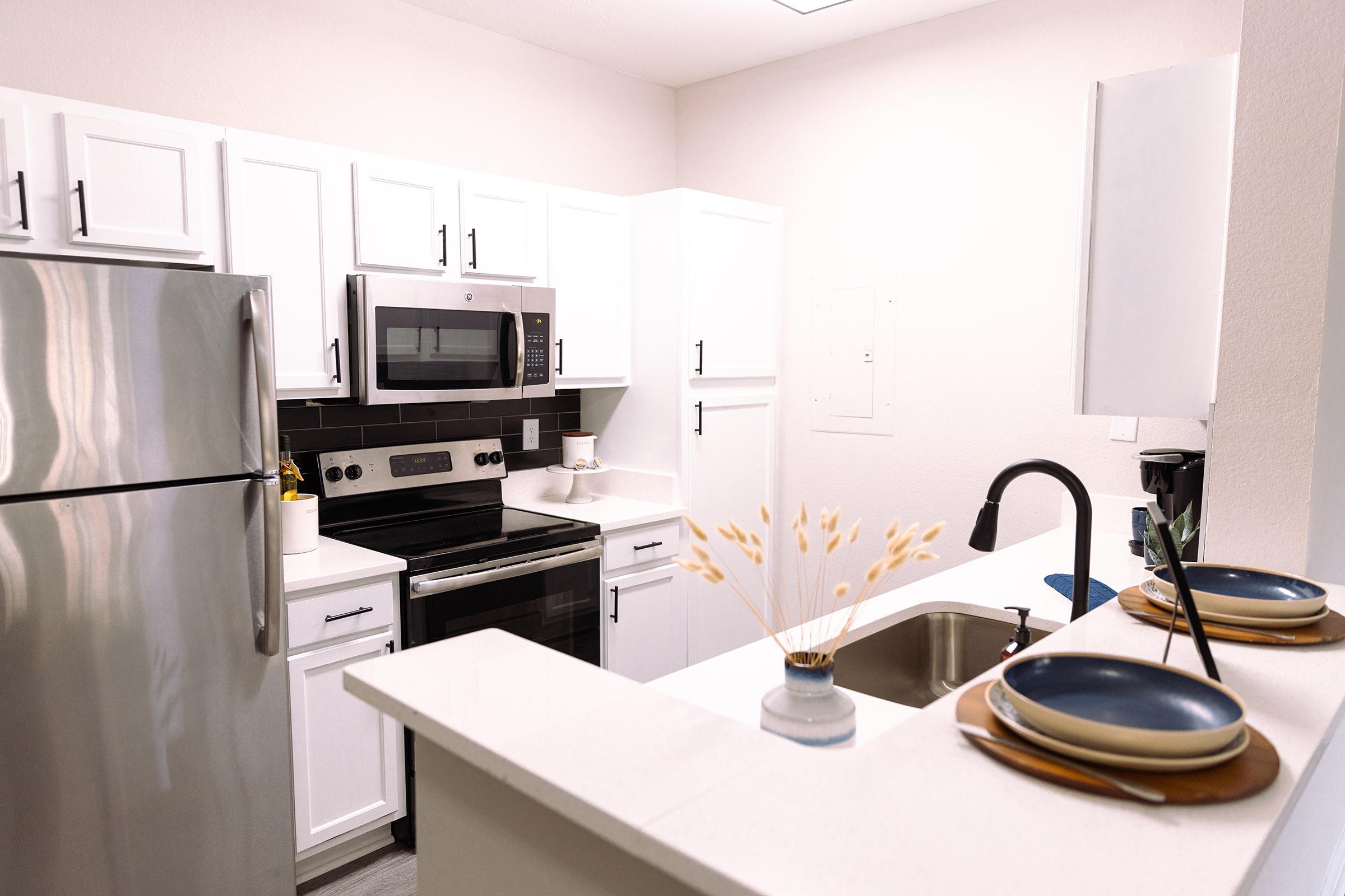 a kitchen with a sink and a microwave
