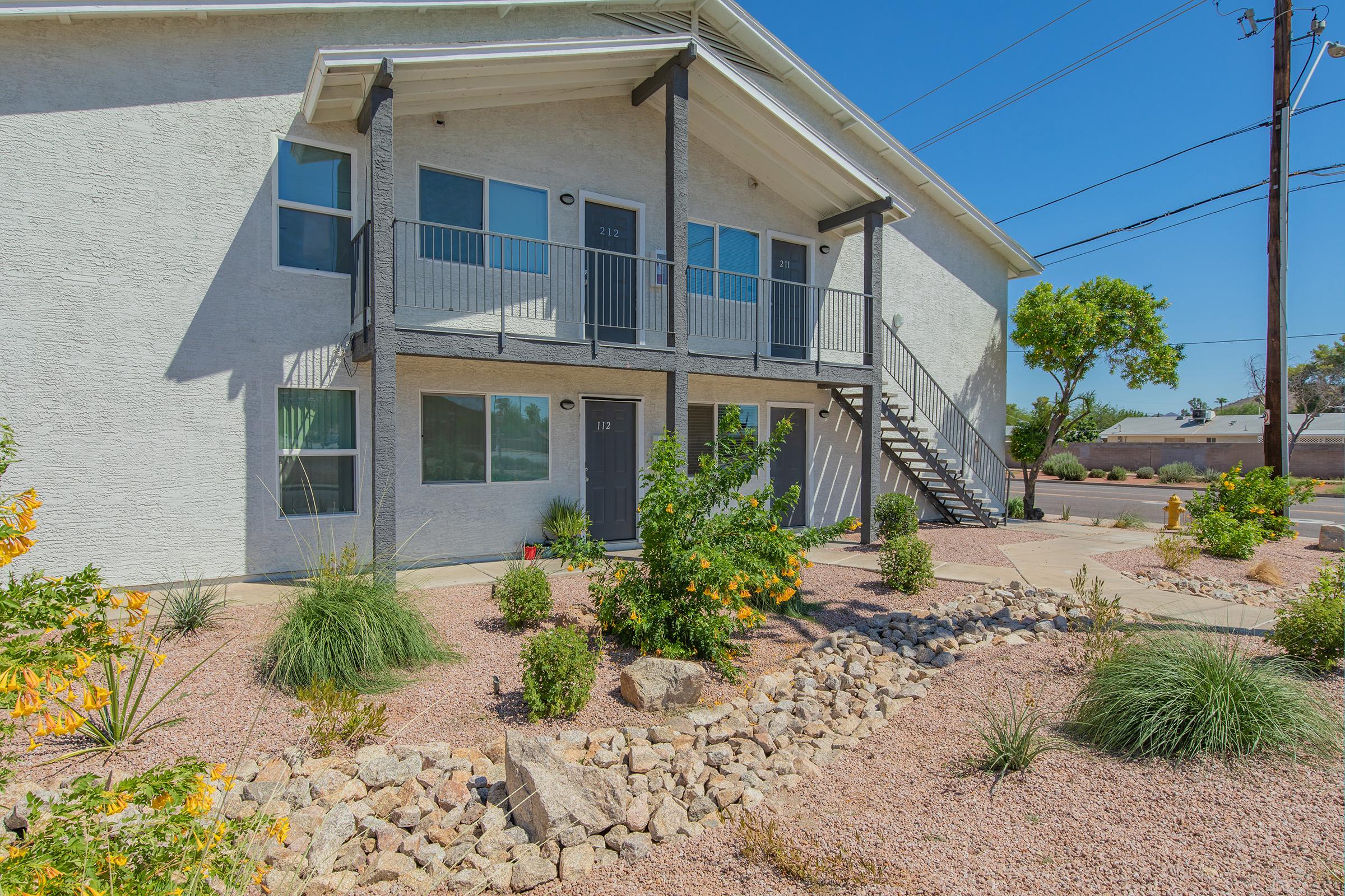 a house with bushes in front of a building