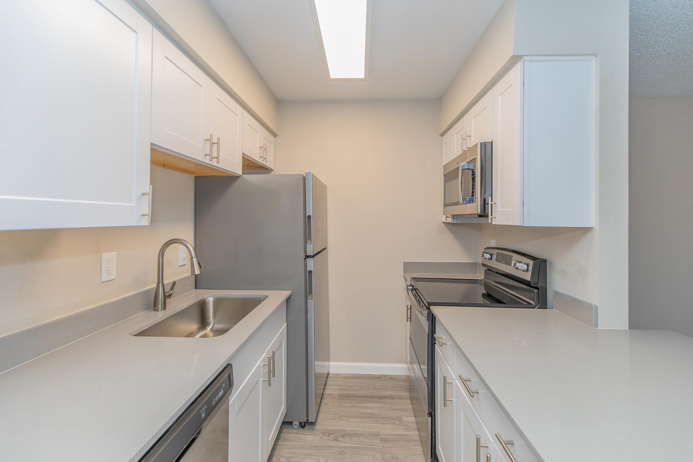 a kitchen with a sink and a refrigerator