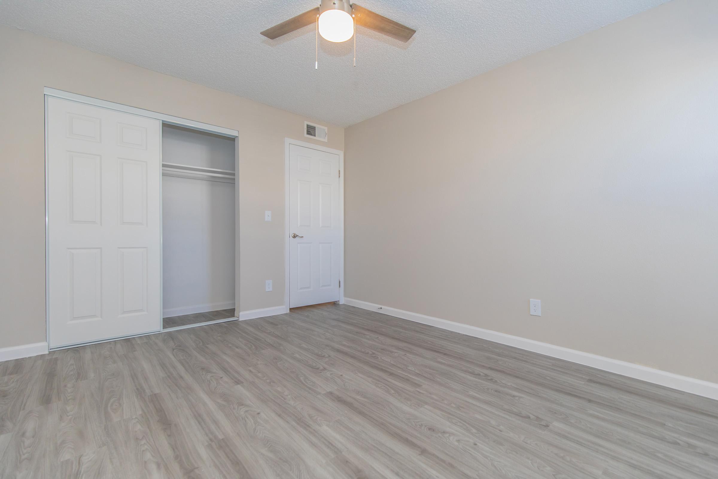 a large empty room with a wooden floor