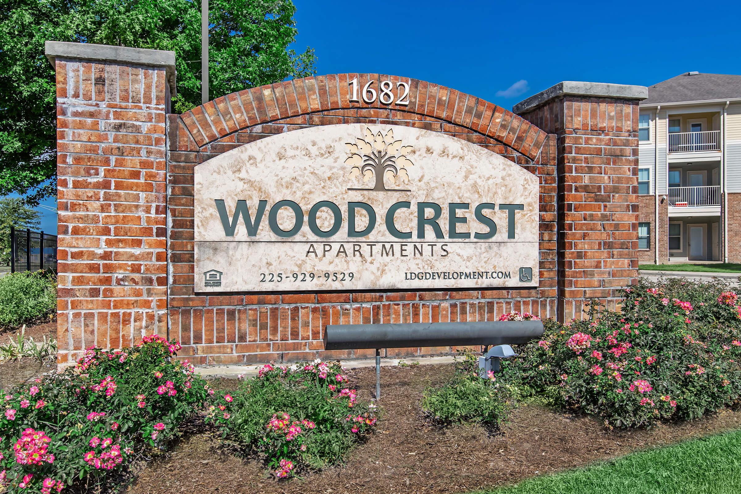 a sign in front of a brick building