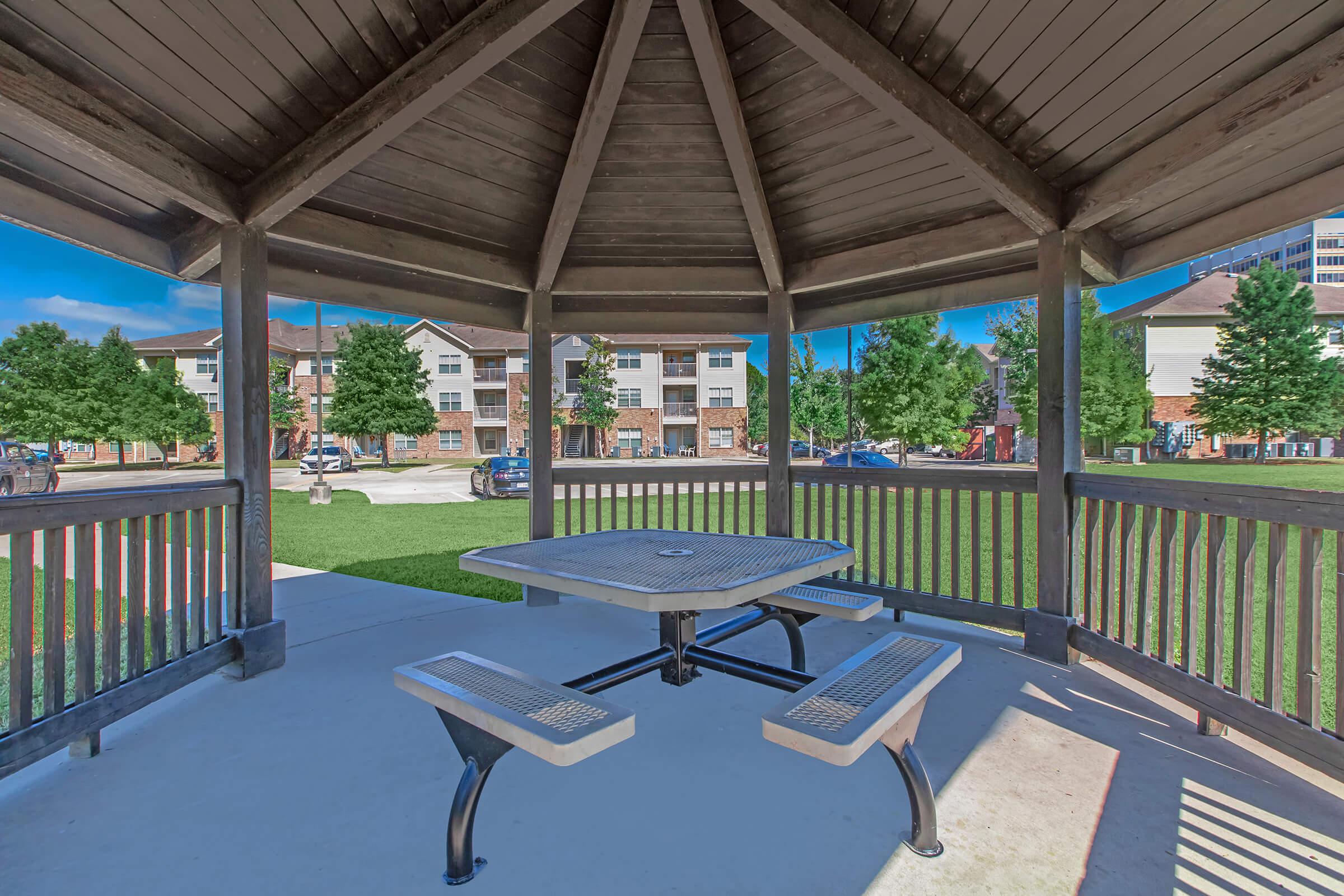 an empty park bench next to a pool