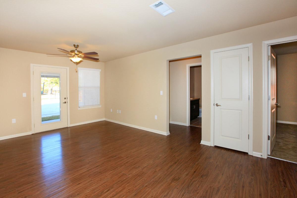 a large empty room with a hard wood floor