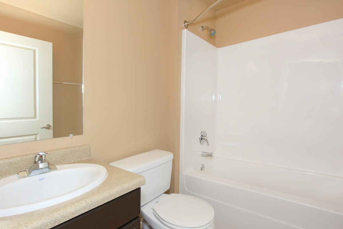 a white tub sitting next to a sink