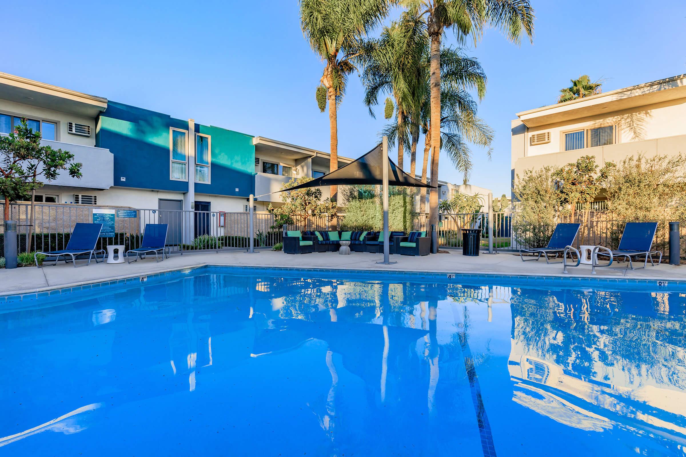 a blue pool of water in front of a building