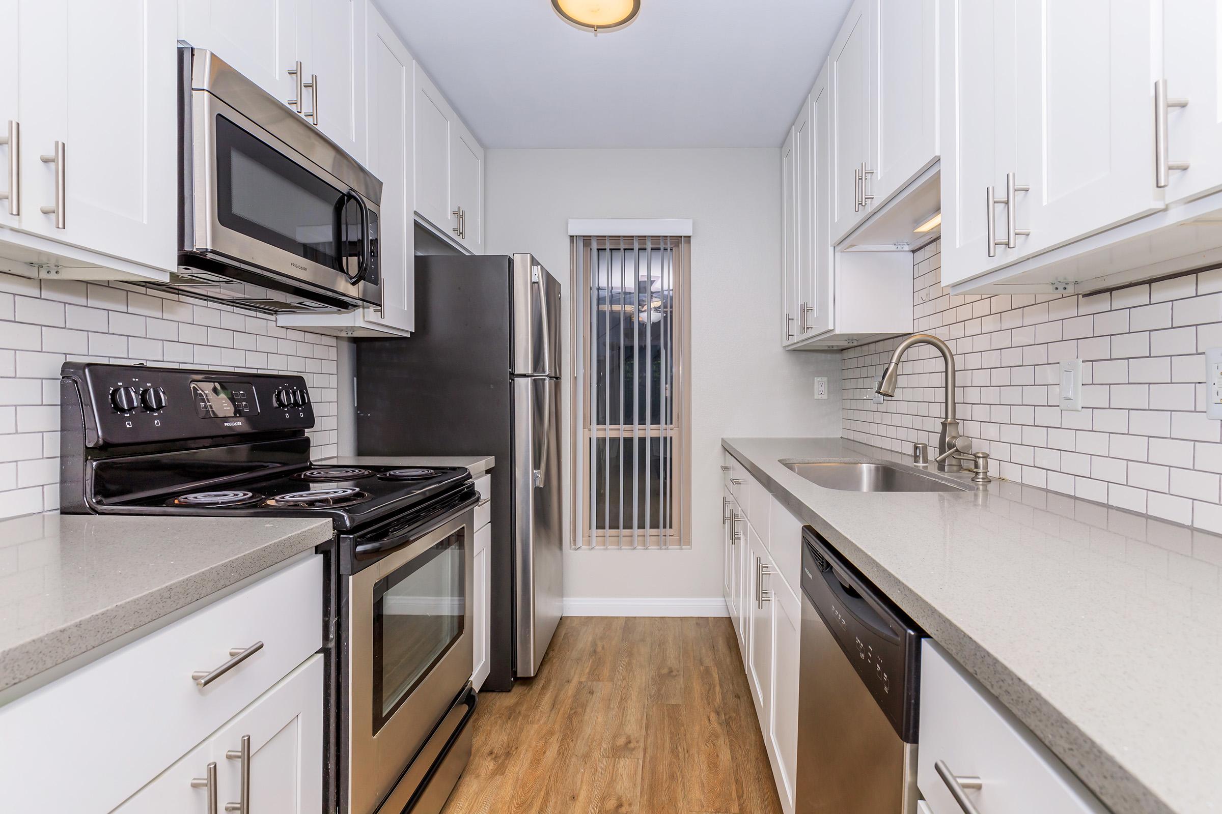 a kitchen with a stove top oven sitting inside of a building