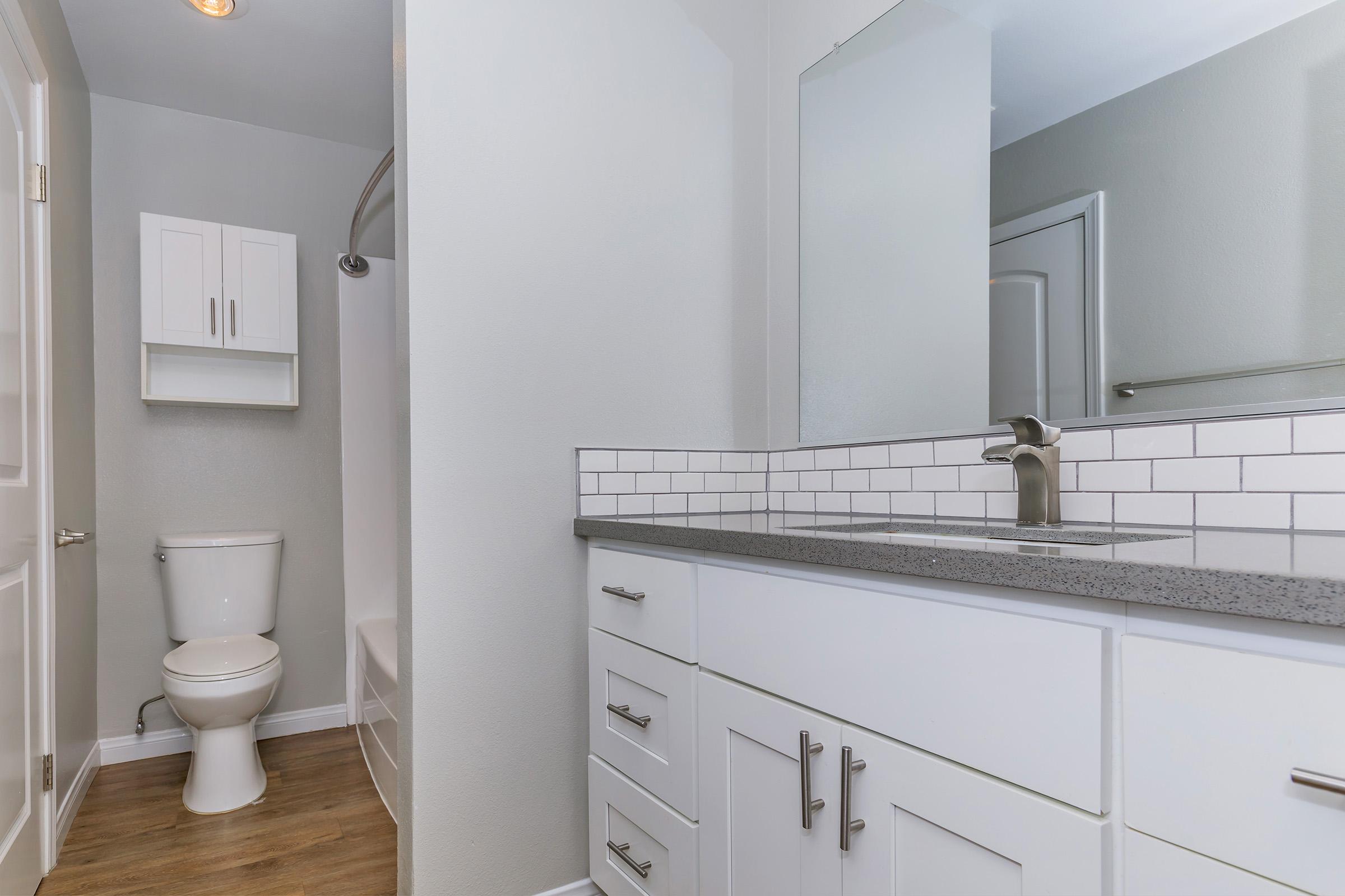 a kitchen with a sink and a mirror