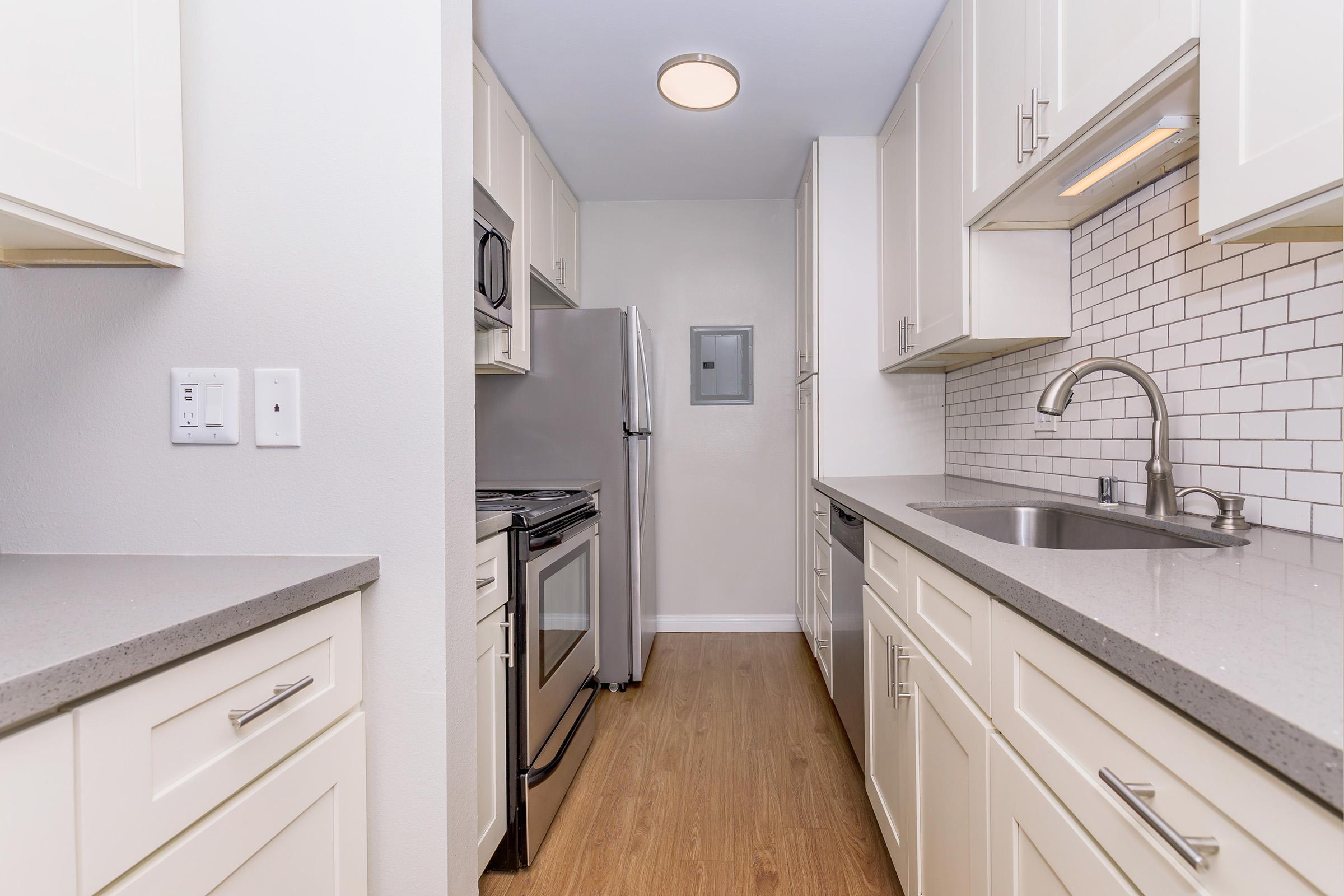 a kitchen with a sink and a refrigerator