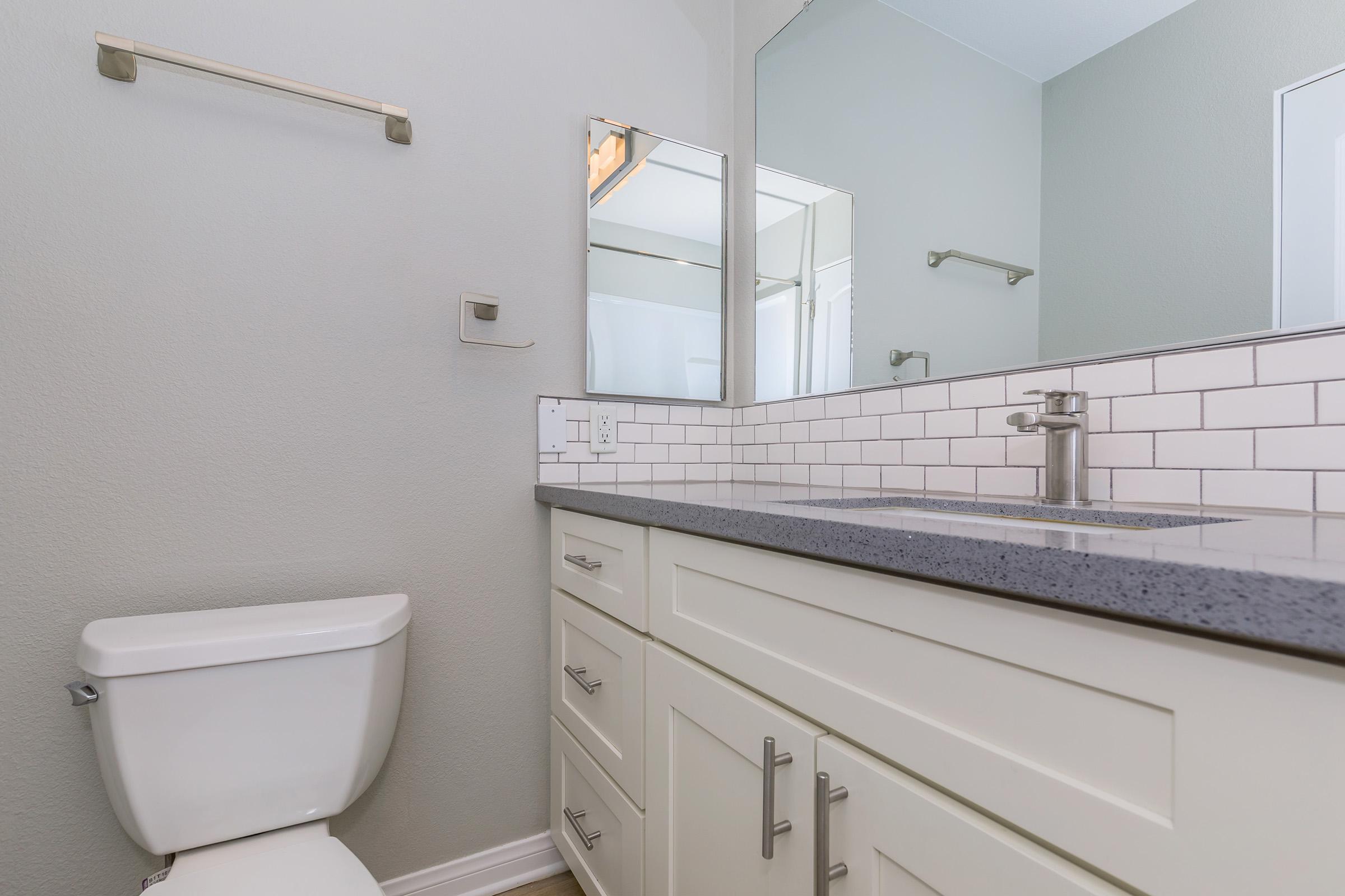 a kitchen with a sink and a mirror