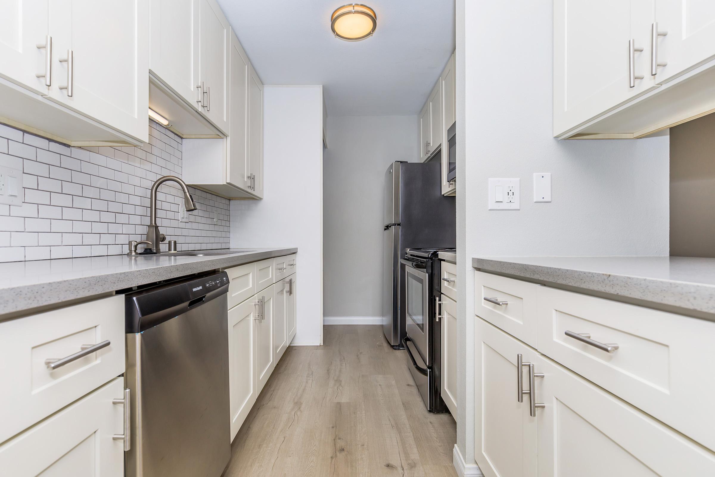 a kitchen with a sink and a refrigerator