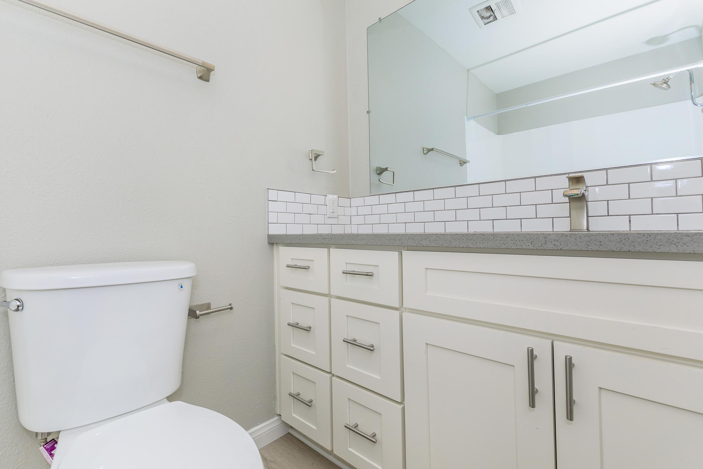 a kitchen with a sink and a mirror