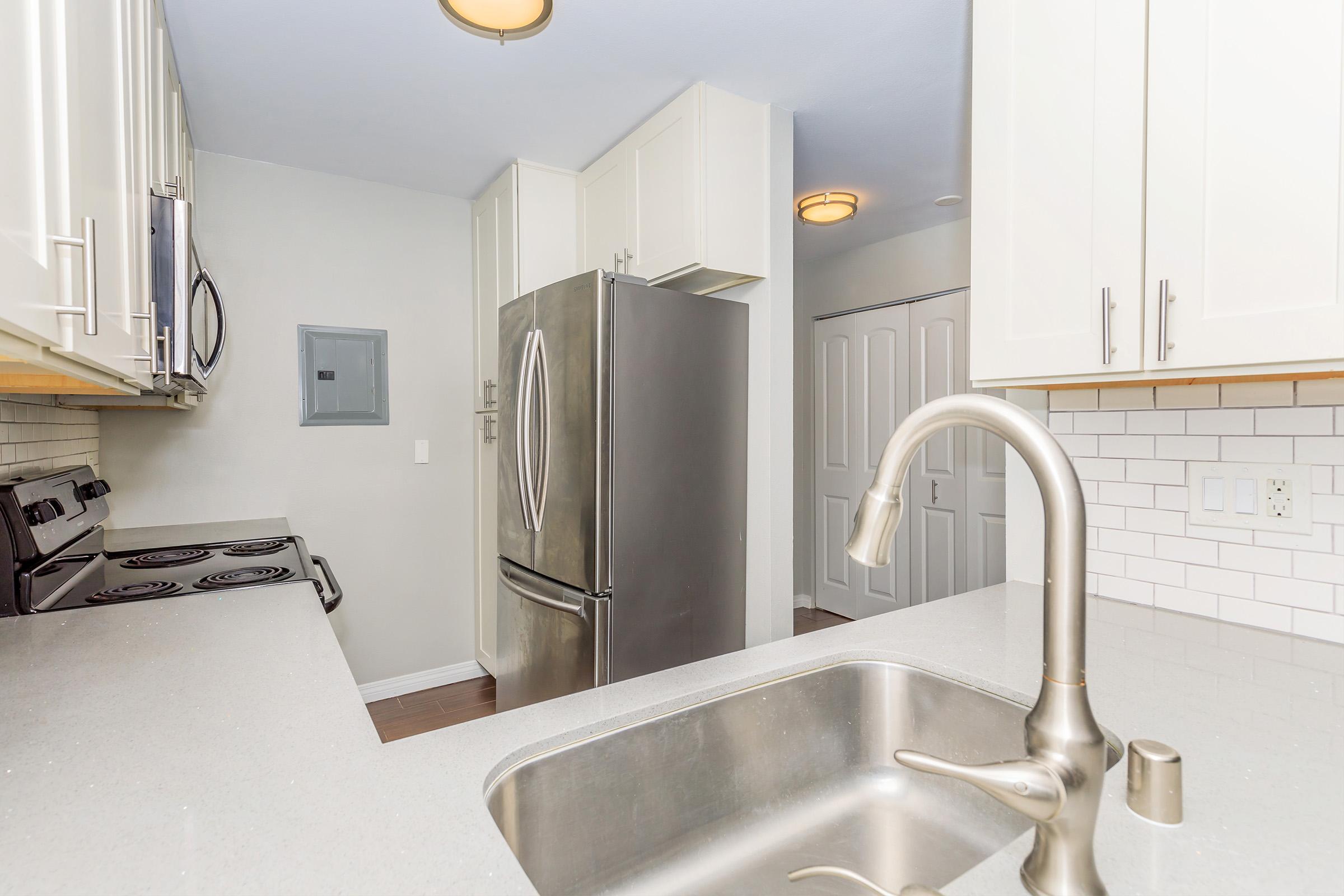 a kitchen with a sink and a mirror