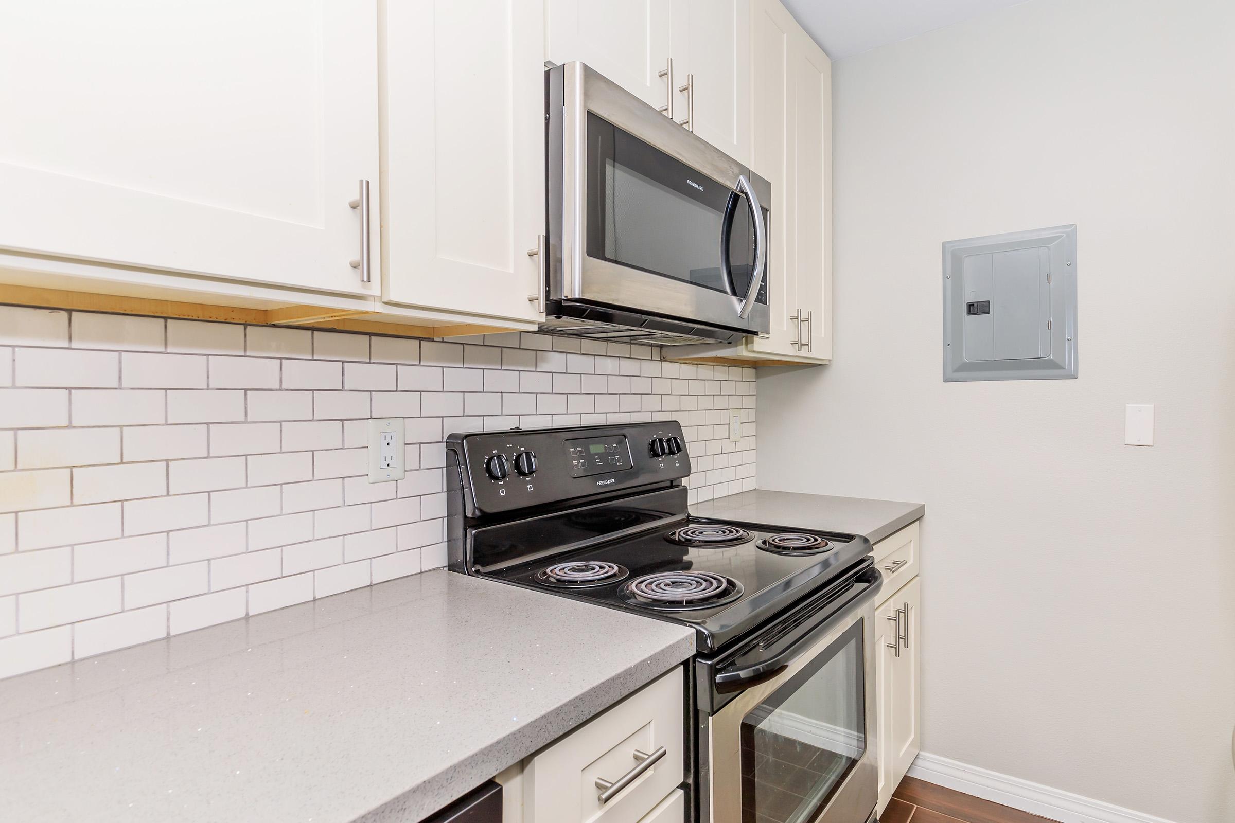 a stove top oven sitting inside of a kitchen