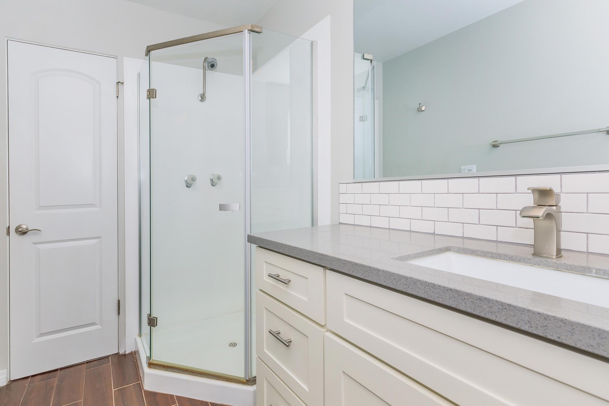 a kitchen with a sink and a mirror