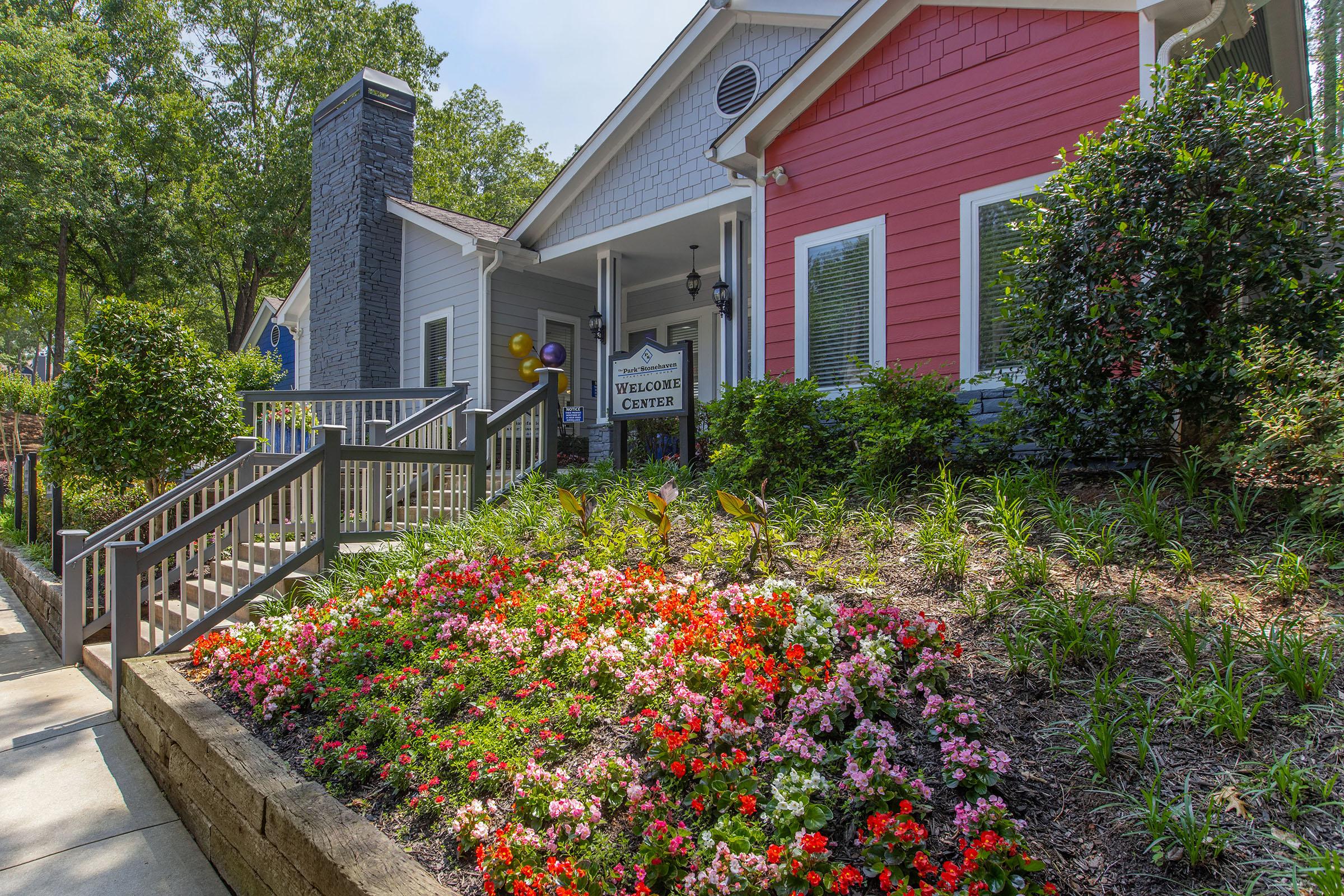 a close up of a flower garden in front of a building