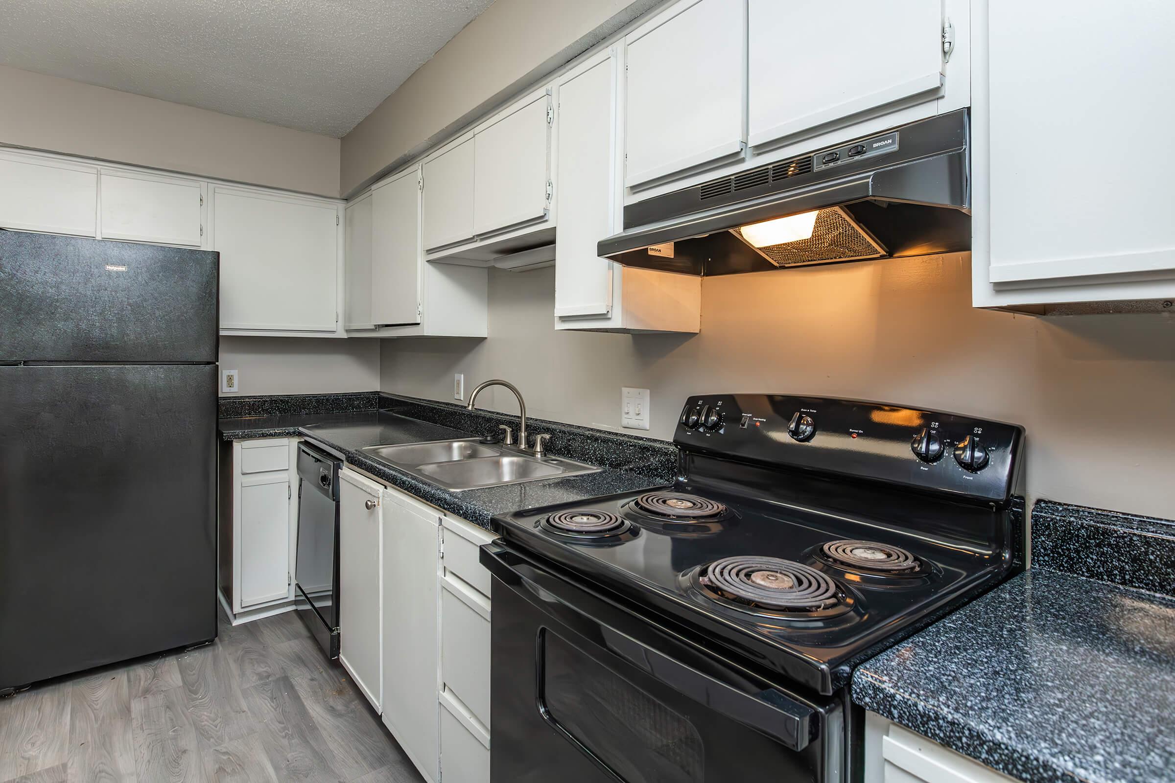 a stove top oven sitting inside of a kitchen