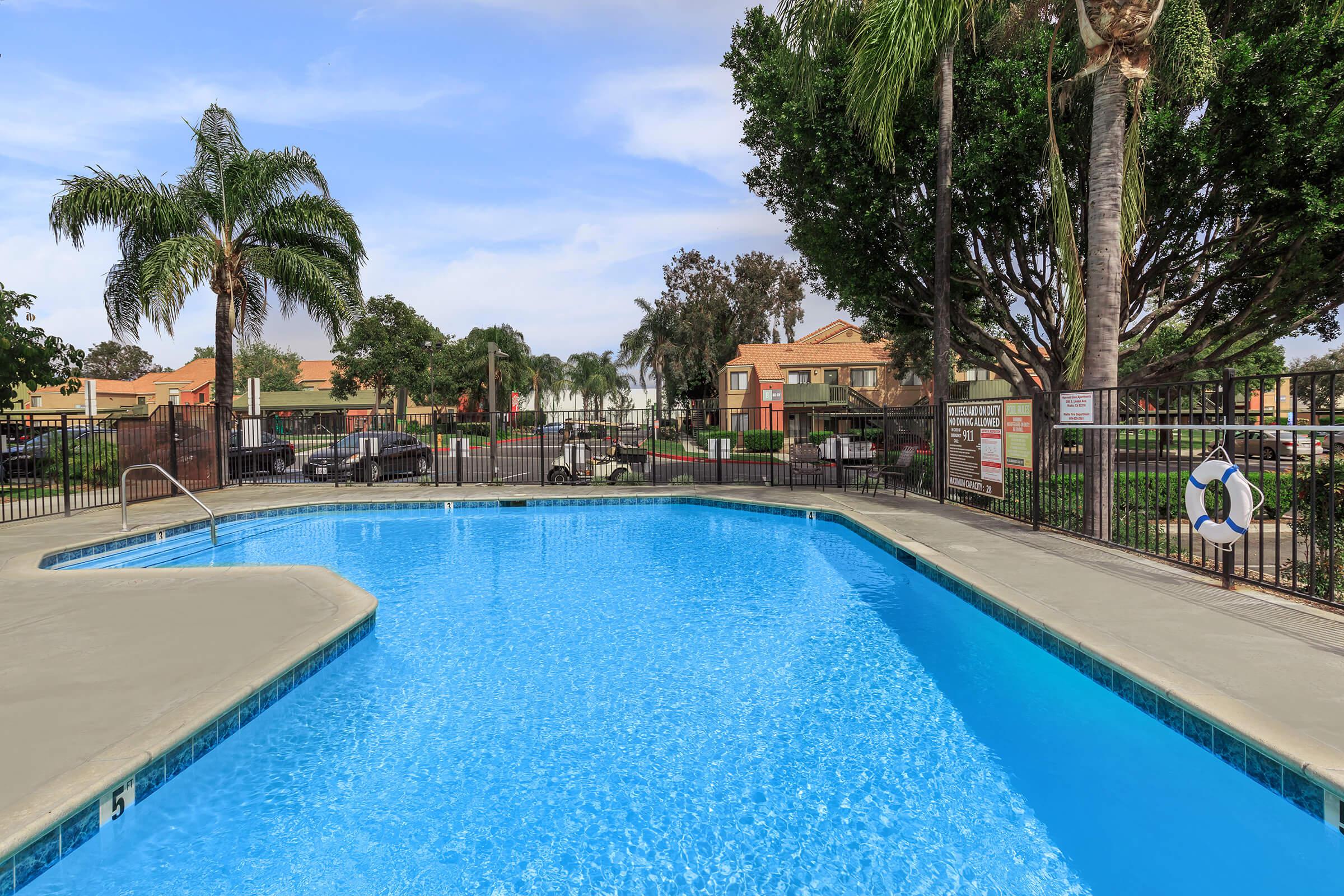 The community pool with green trees