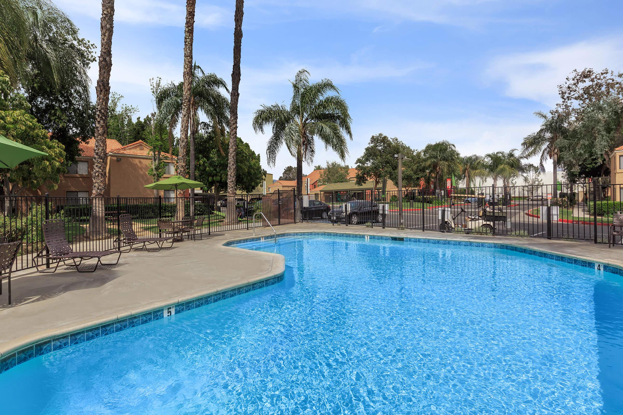 Harvest Glen community pool with green umbrellas