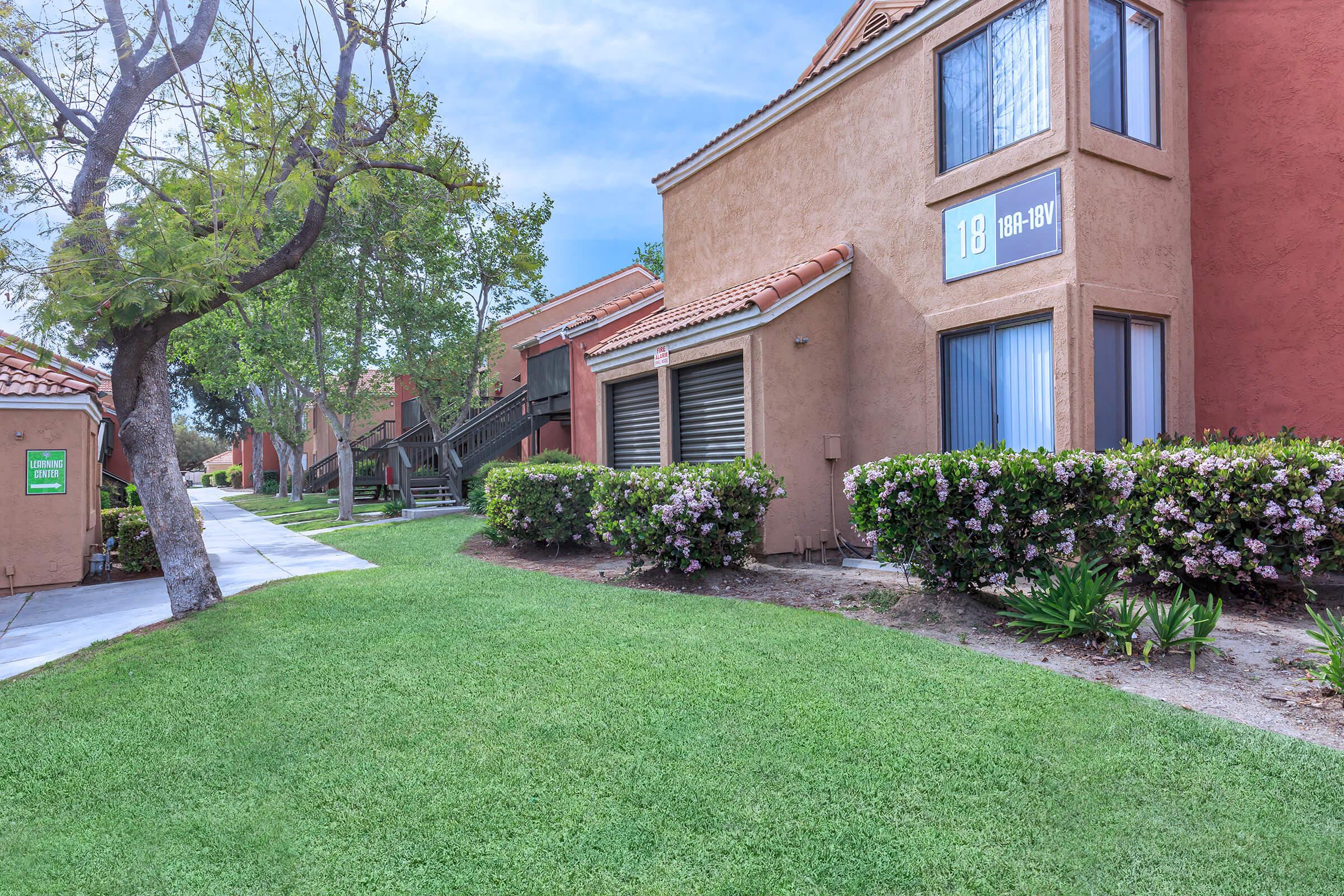 Community building with green shrubs with flowers