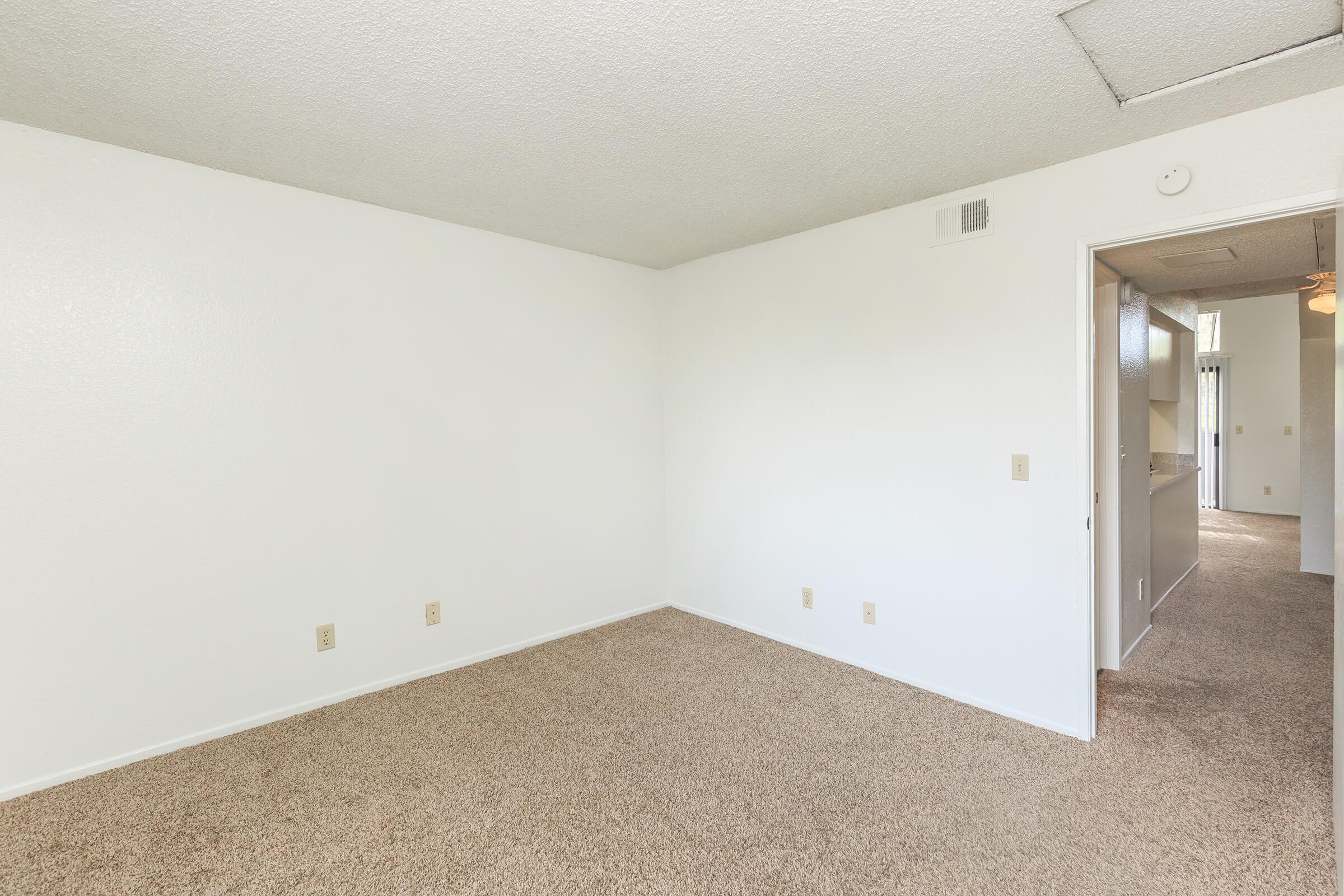 Room and hallway with carpet