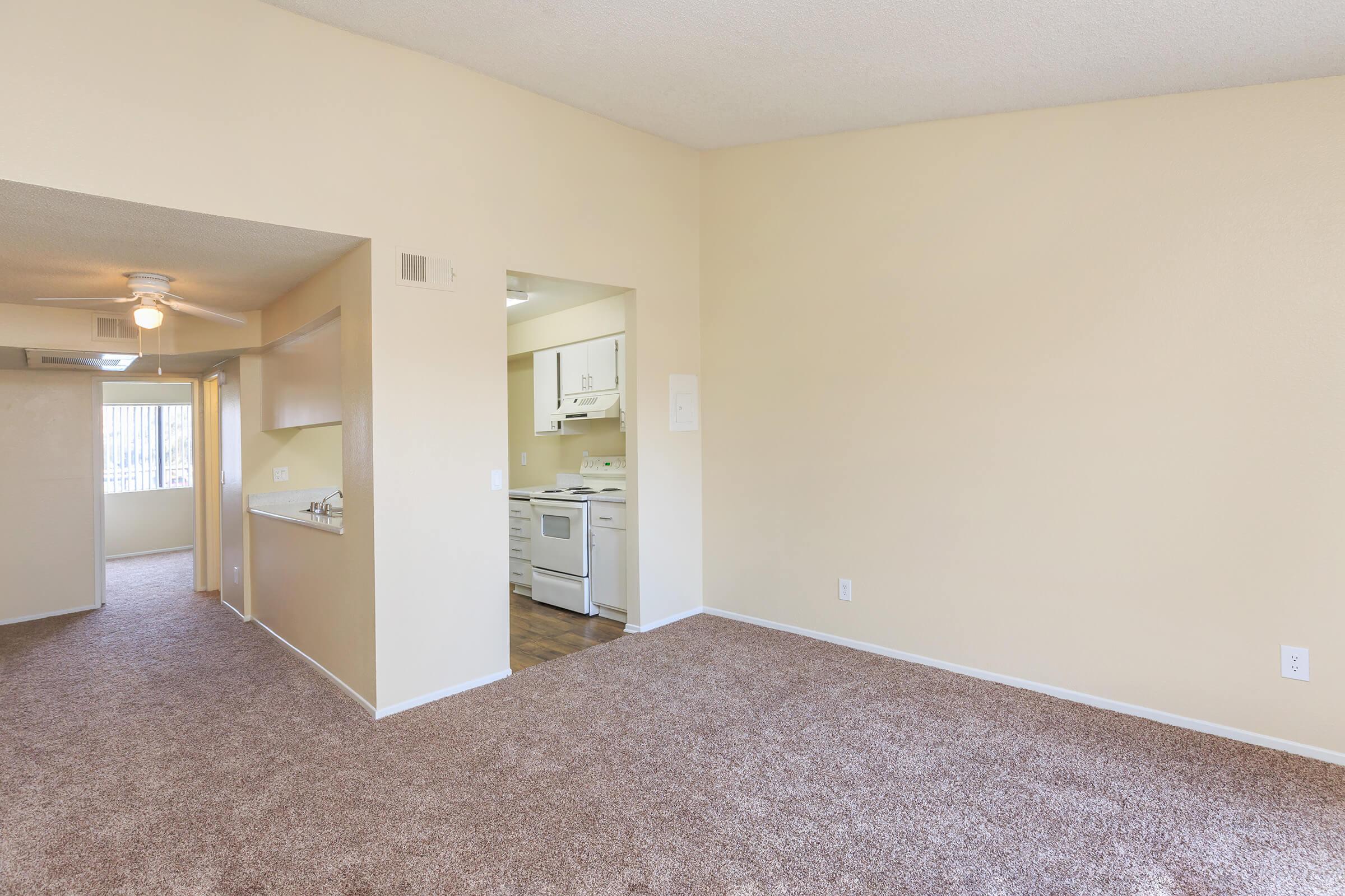 Vacant living room and dining room with carpet