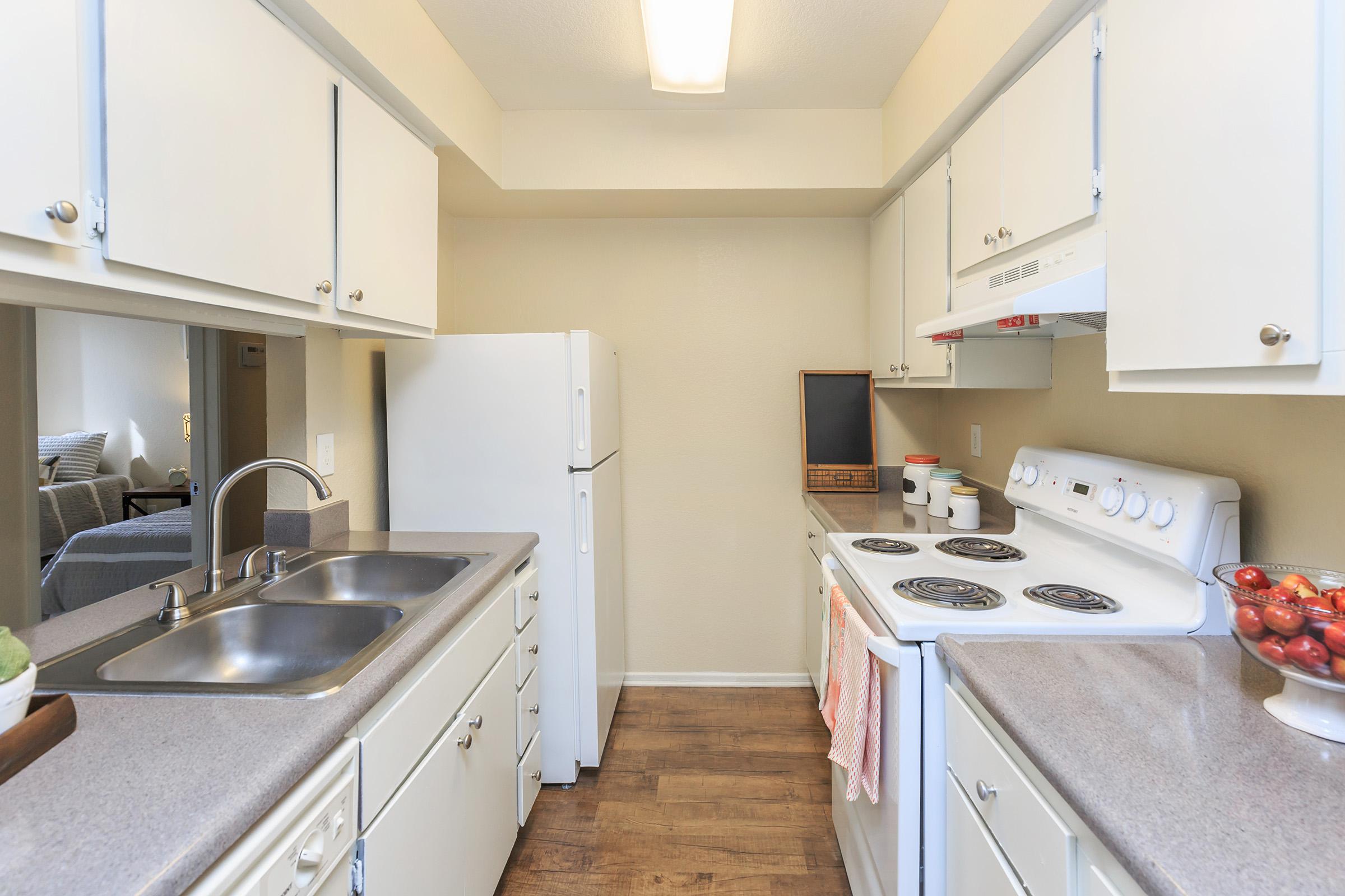 Furnished kitchen with white cabinets