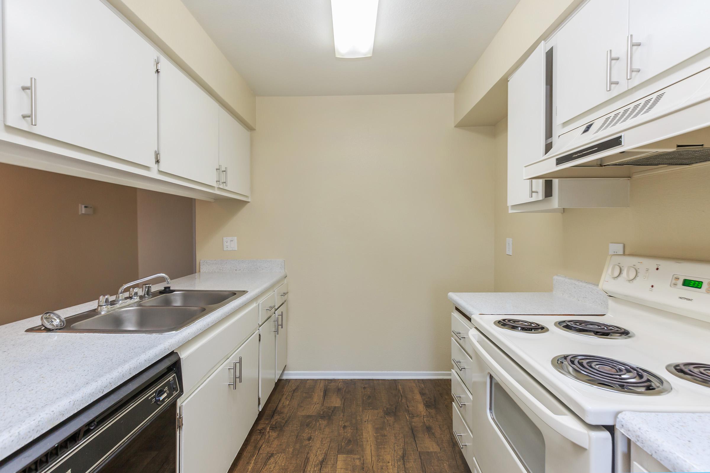 Vacant kitchen with white appliances