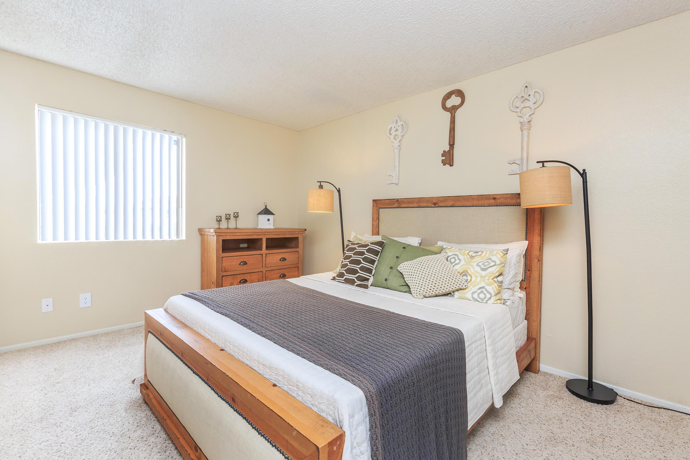 Furnished bedroom with a wooden dresser